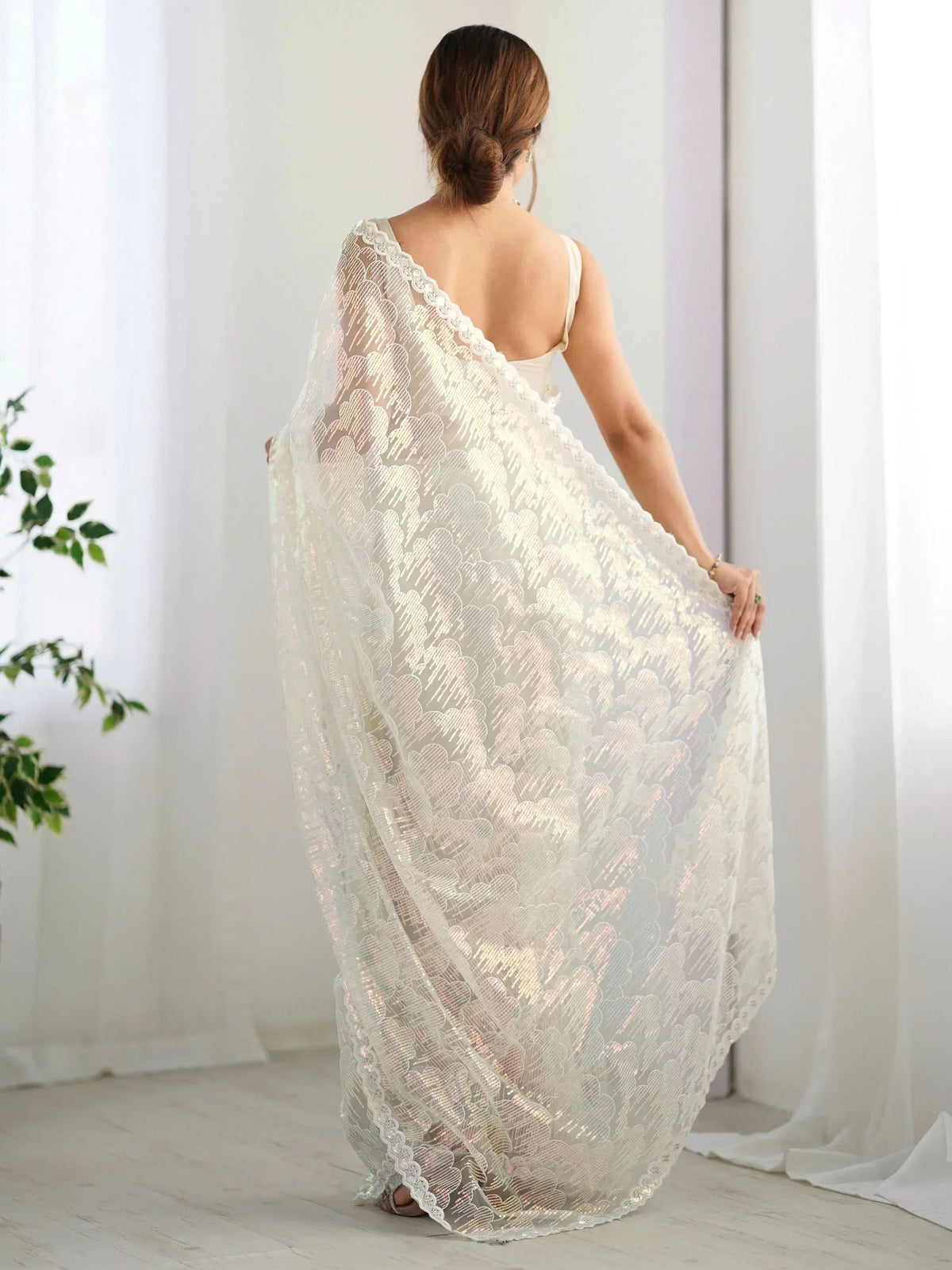 Elegant white sequin saree with scalloped lace, perfect for Indian ethnic wear occasions