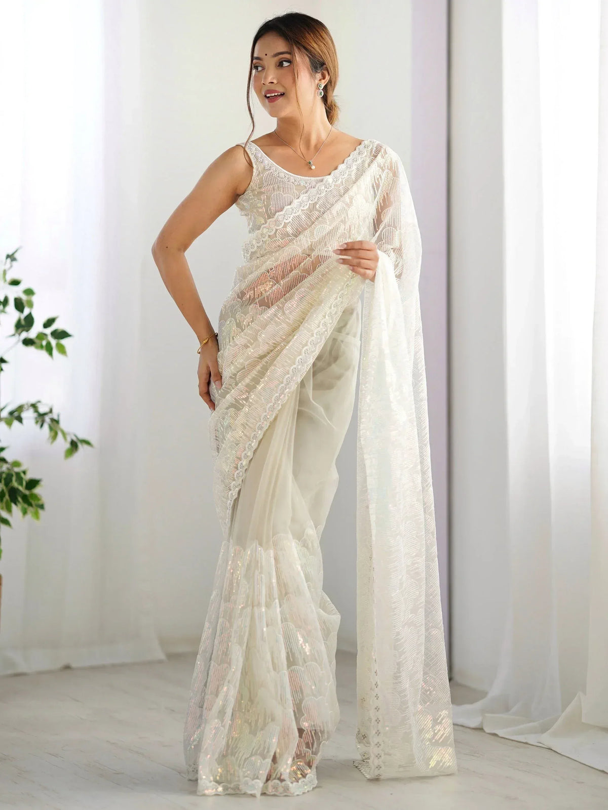 Elegant white designer saree with lace and sequin detailing, perfect for Indian ethnic wear occasions.