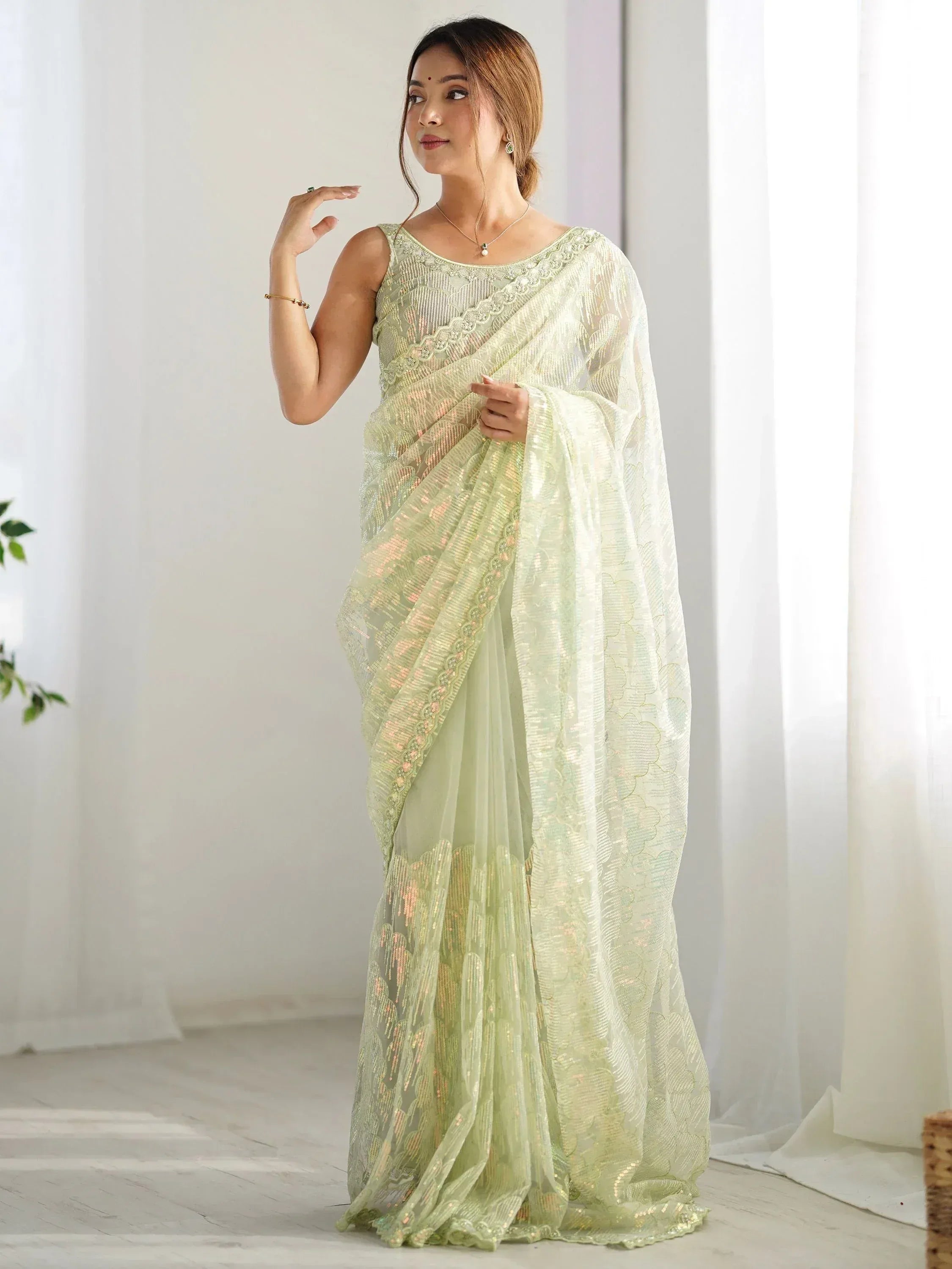 Light green embroidered saree with sequin work, perfect for Indian ethnic occasions
