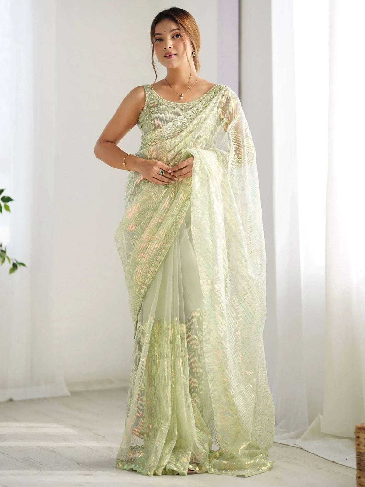 Light green designer saree with sequin embroidery and lace detailing, perfect for ethnic occasions
