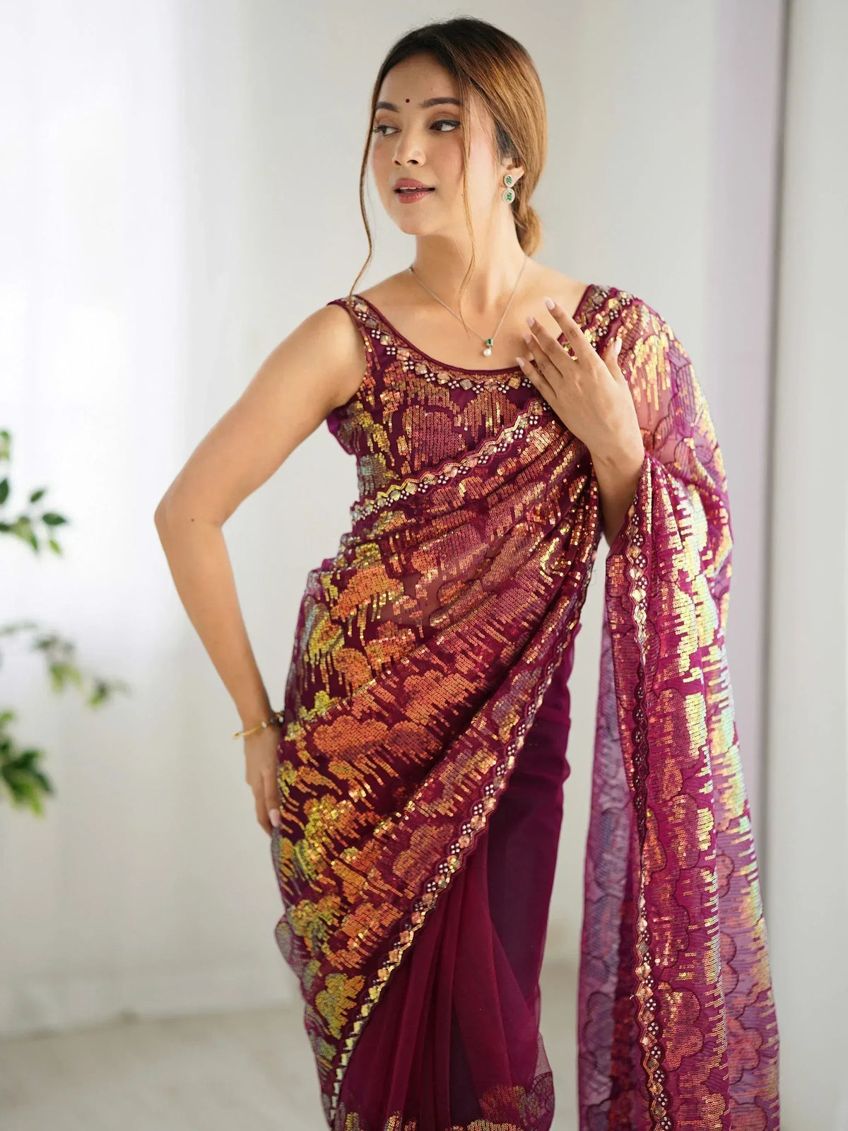 Woman in maroon sequin saree with gold embroidery, Indian ethnic wear for festive occasions