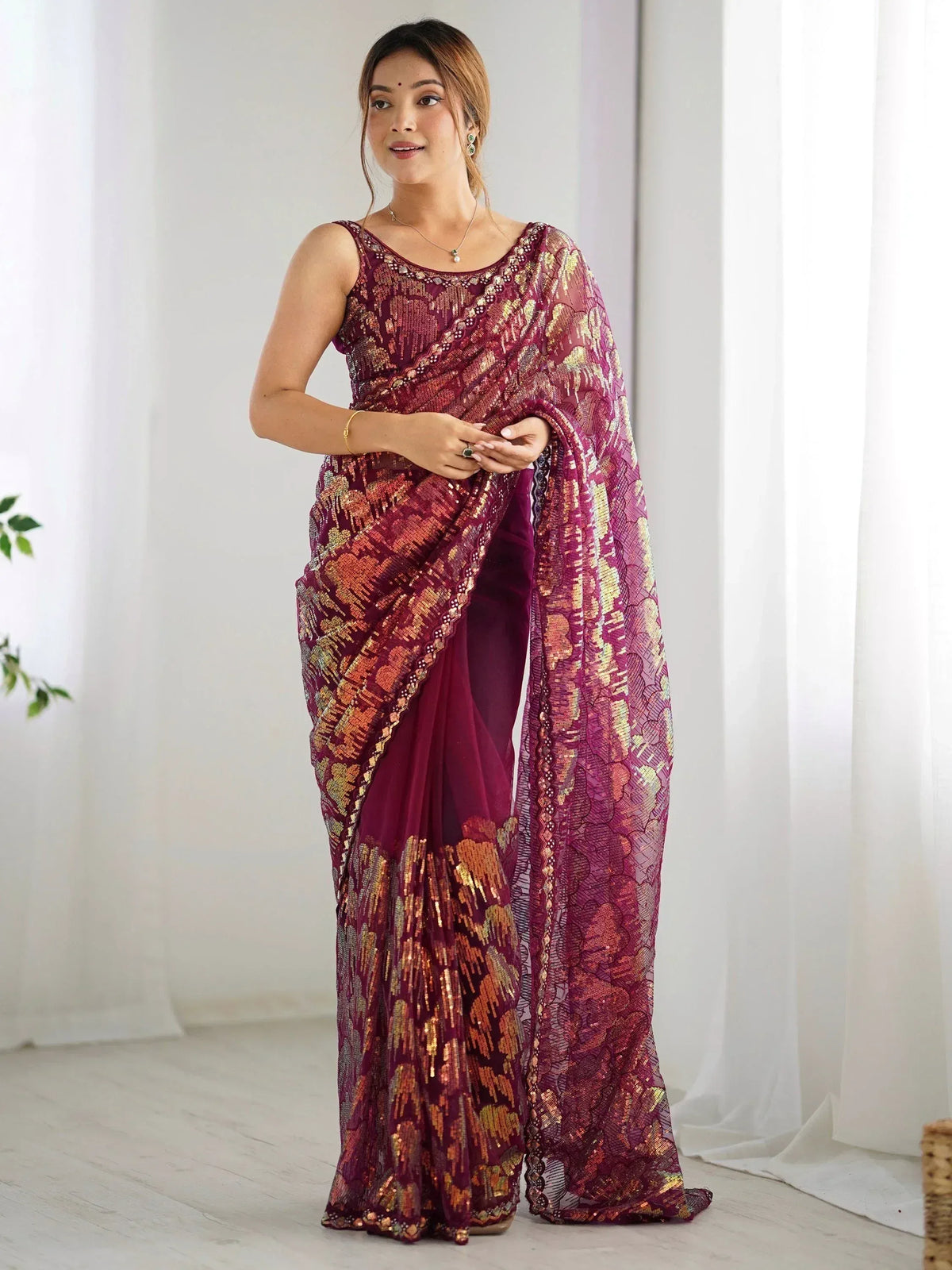 Elegant maroon saree with gold sequin work and sheer blouse, perfect for Indian ethnic occasions