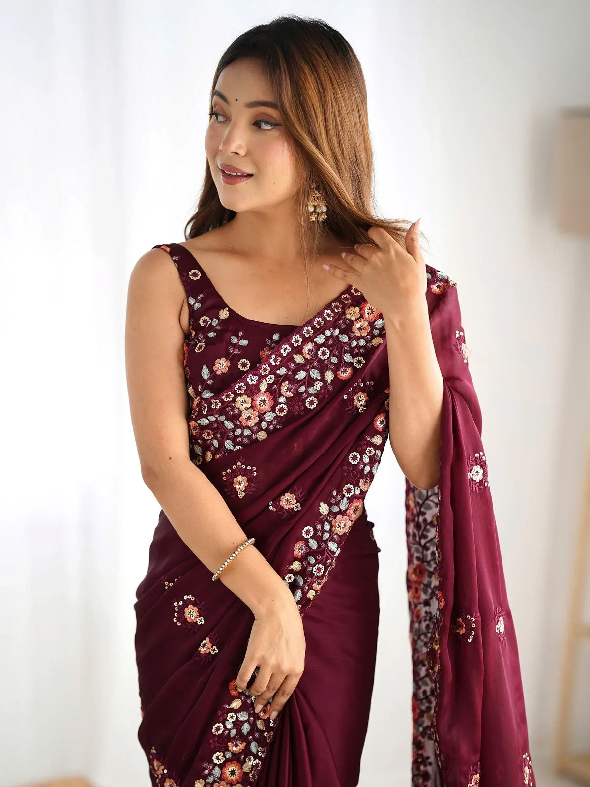 Woman in maroon floral embroidered saree with designer blouse, ethnic Indian wear