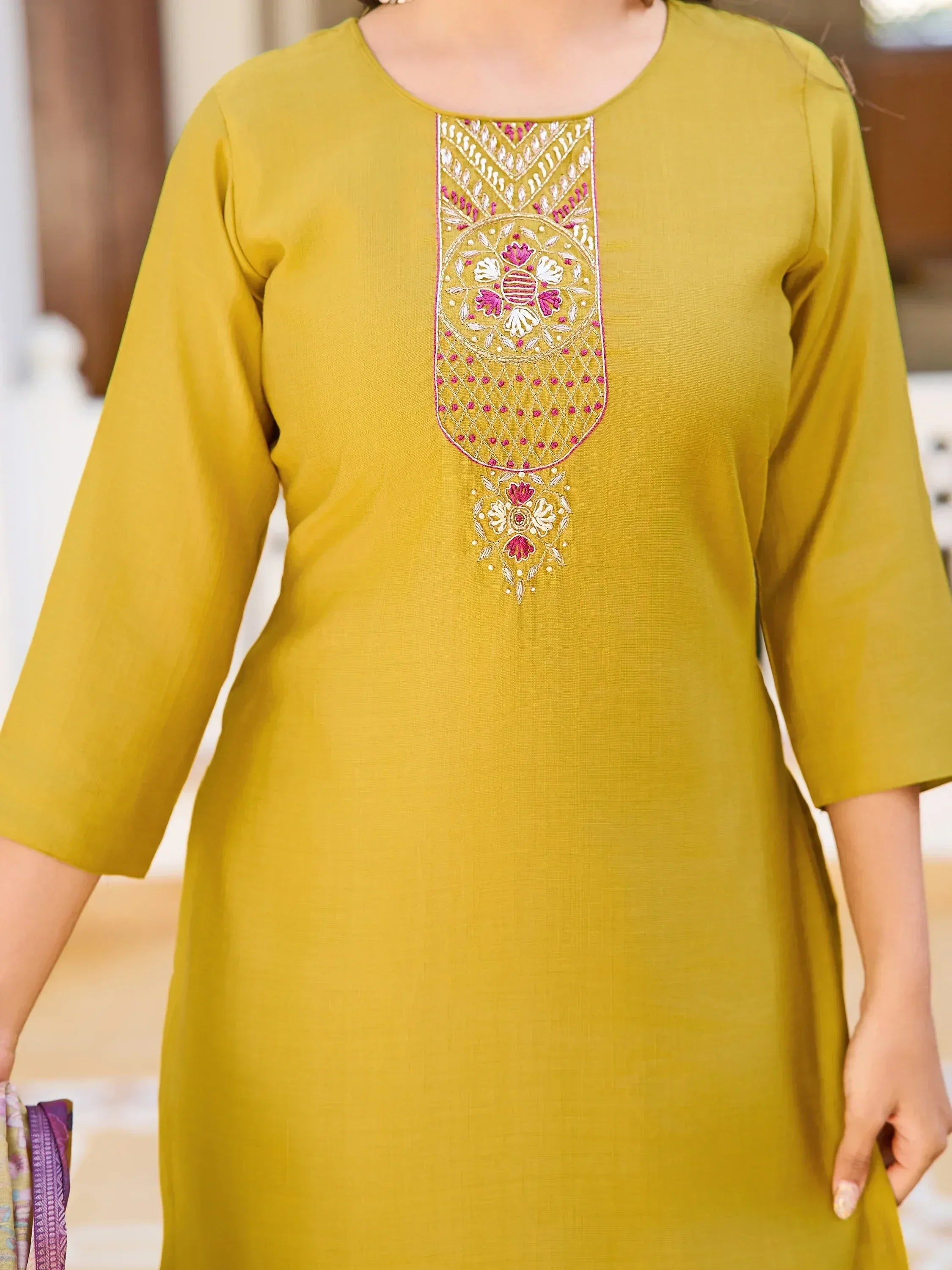 Mustard yellow ethnic kurti with pink and white floral embroidery, perfect for Indian wear