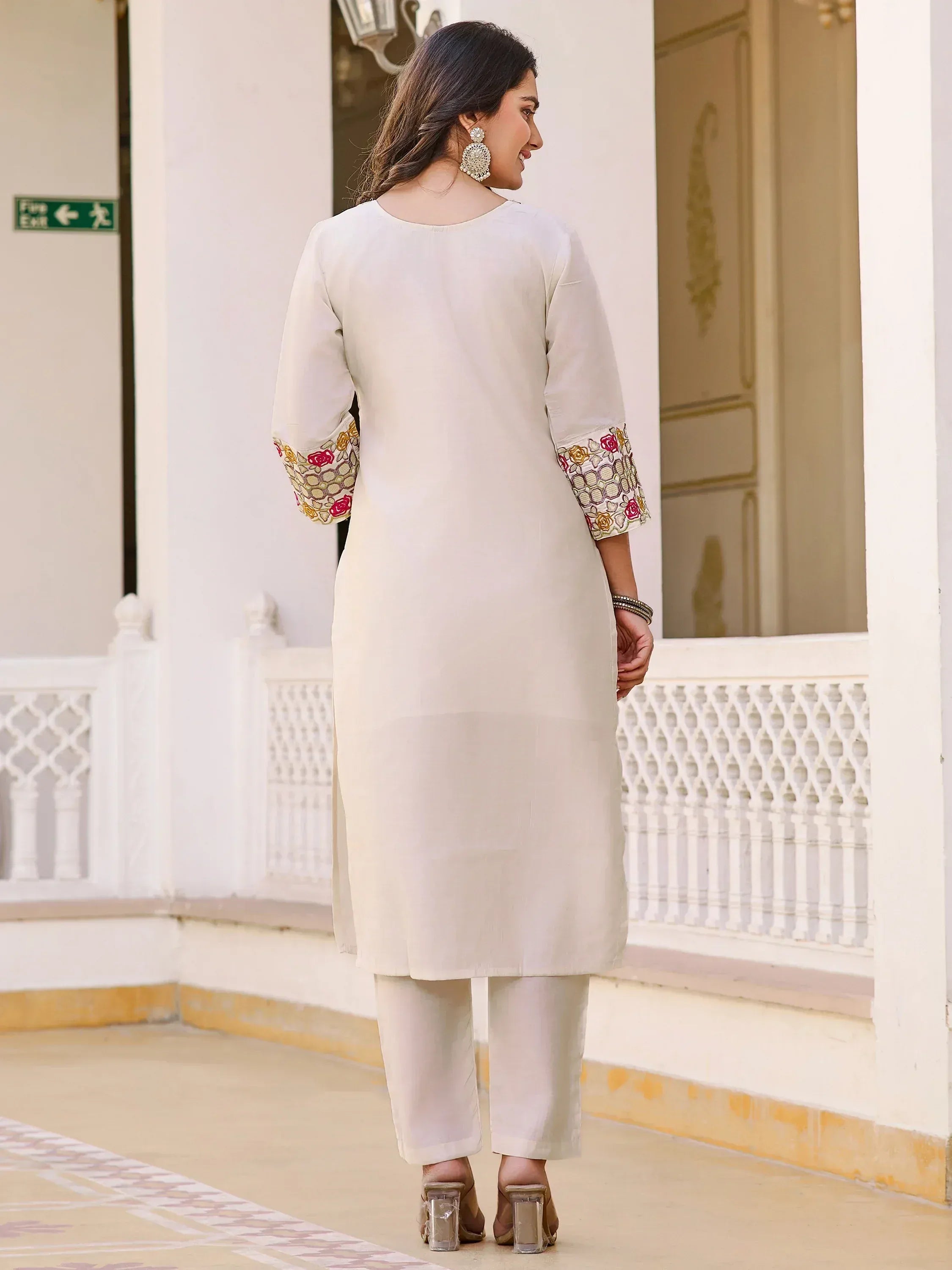 Cream ethnic kurti with floral sleeve embroidery, paired with matching pants for Indian wear
