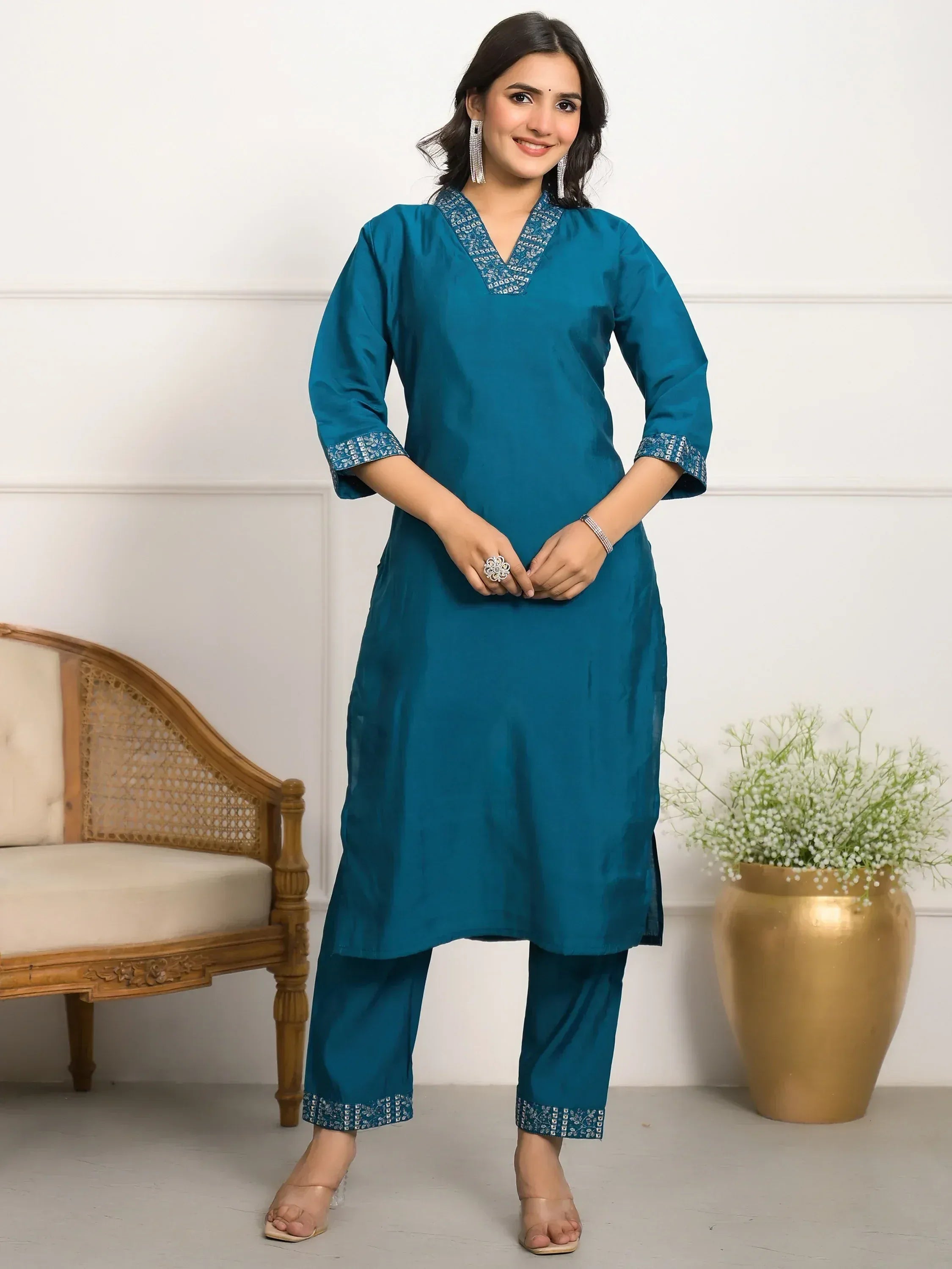 Teal ethnic kurti with embroidered neckline and cuffs, paired with matching palazzo pants for women.