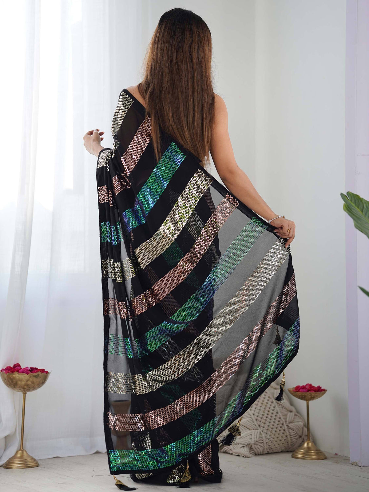 Black and grey saree with multicolor sequin stripes and tassels, styled for ethnic wear