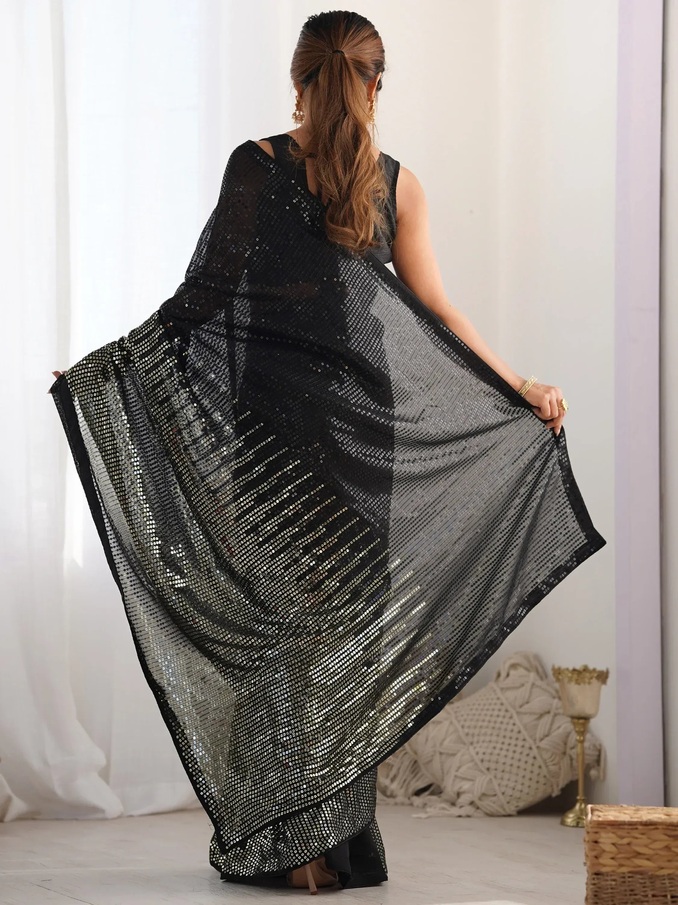 Black sequin saree with shimmering details, perfect for ethnic wear occasions