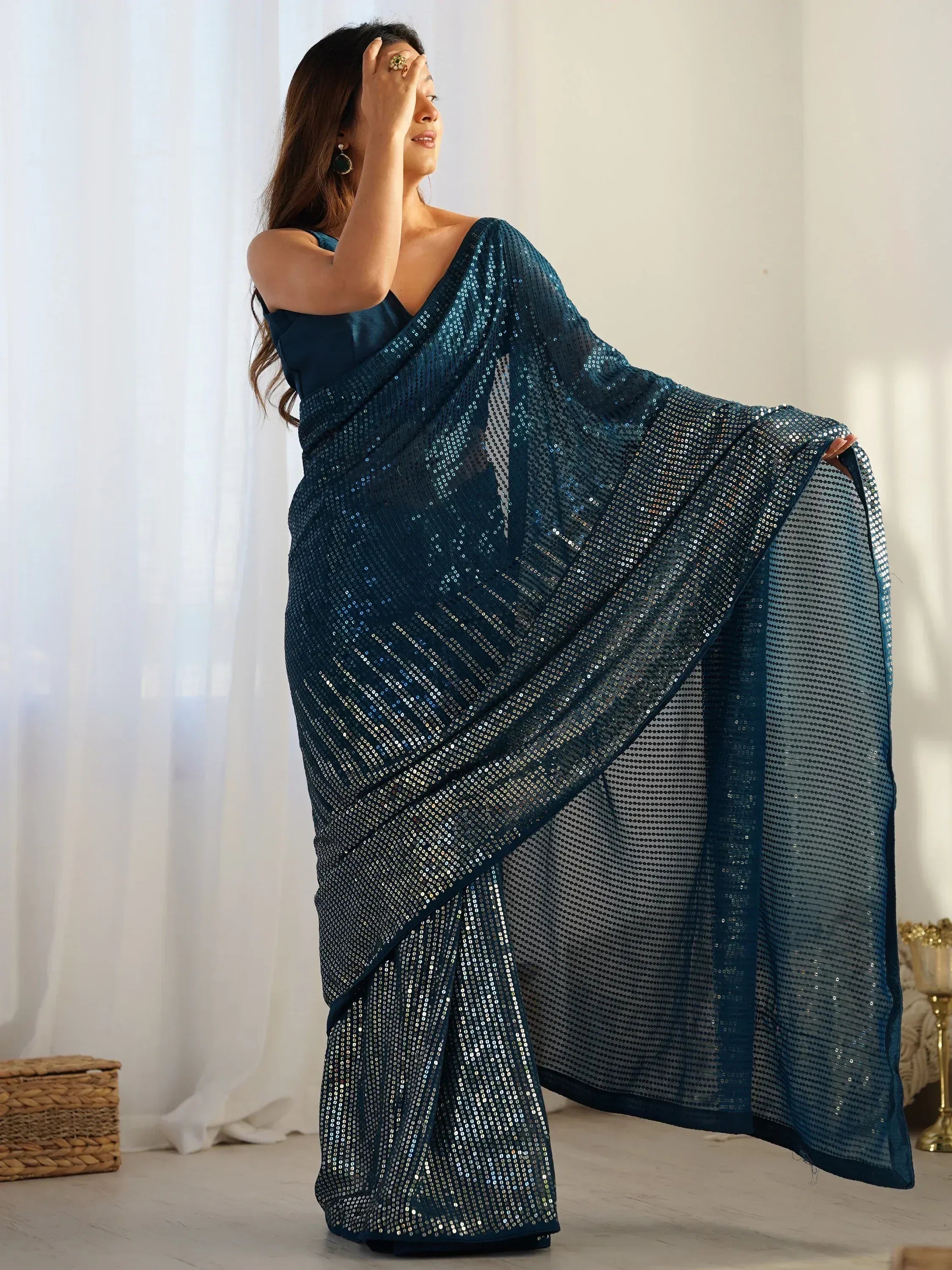 Woman in elegant teal sequin saree, Indian ethnic wear for festive occasions