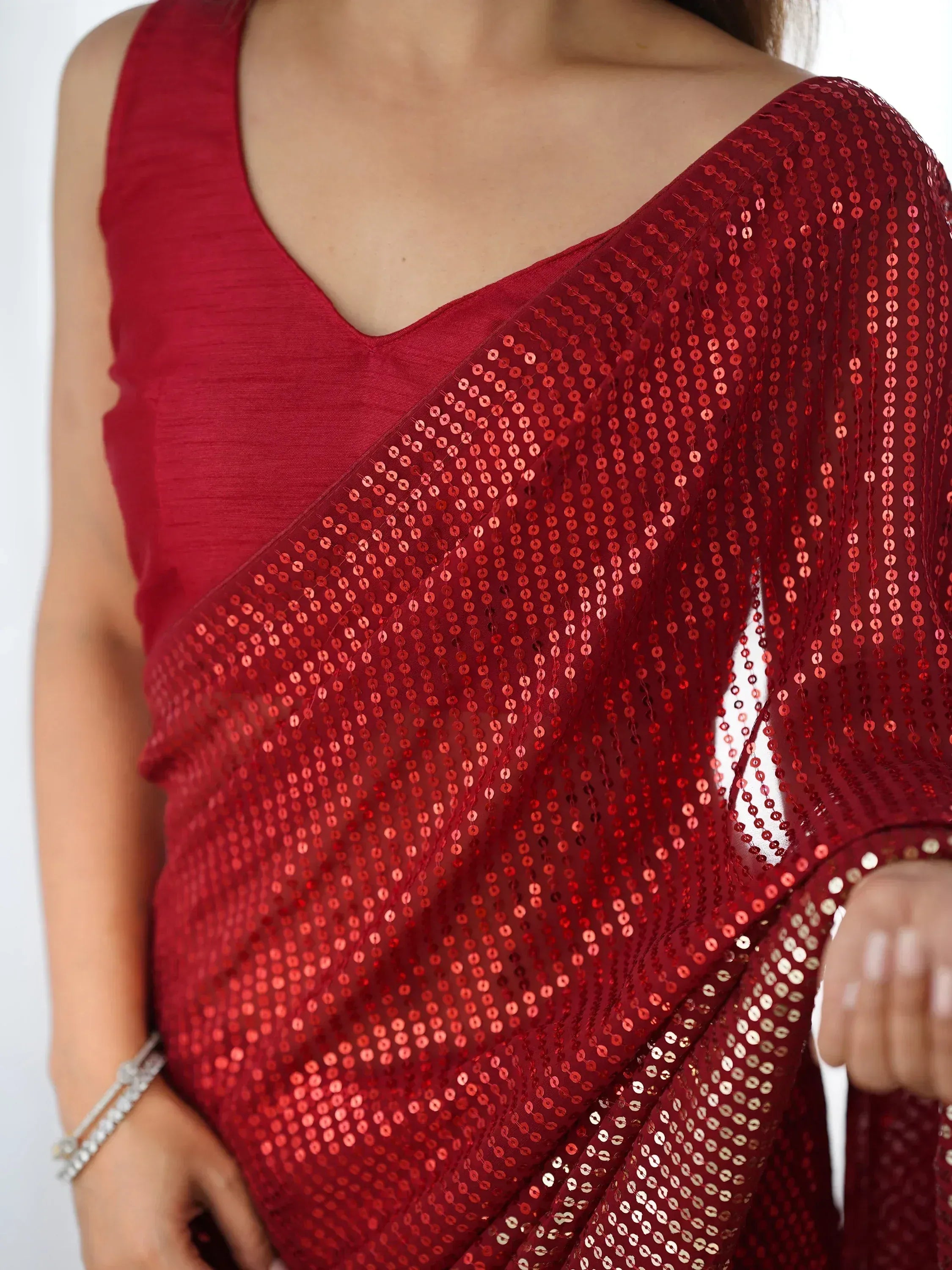 Red sequin saree with sleeveless blouse, ethnic Indian wear for festive occasions