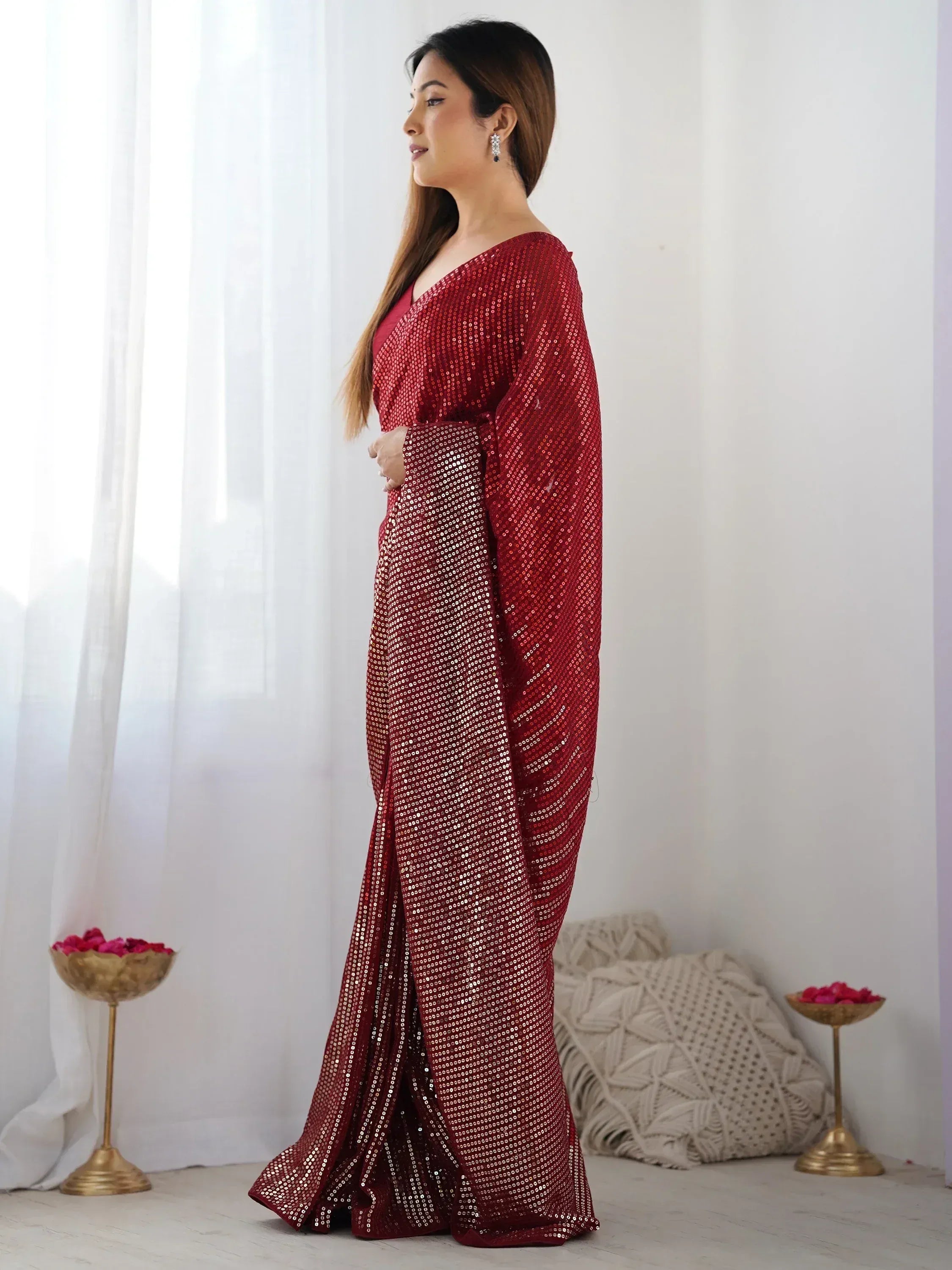 Woman in red sequin saree with V-neck blouse, ethnic Indian wear for festive occasions