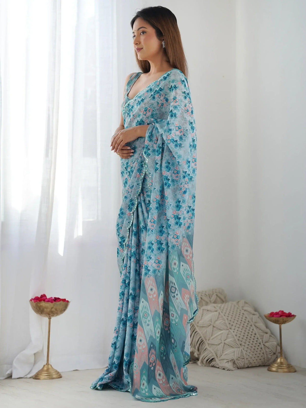 Woman in blue printed saree with sequin border, ethnic Indian wear for festive occasions