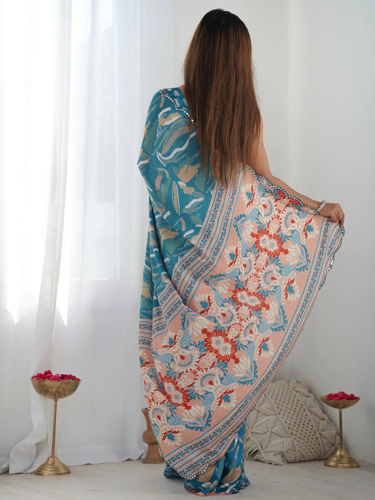 Woman wearing floral printed Indian saree with blue and peach design, ethnic wear for women