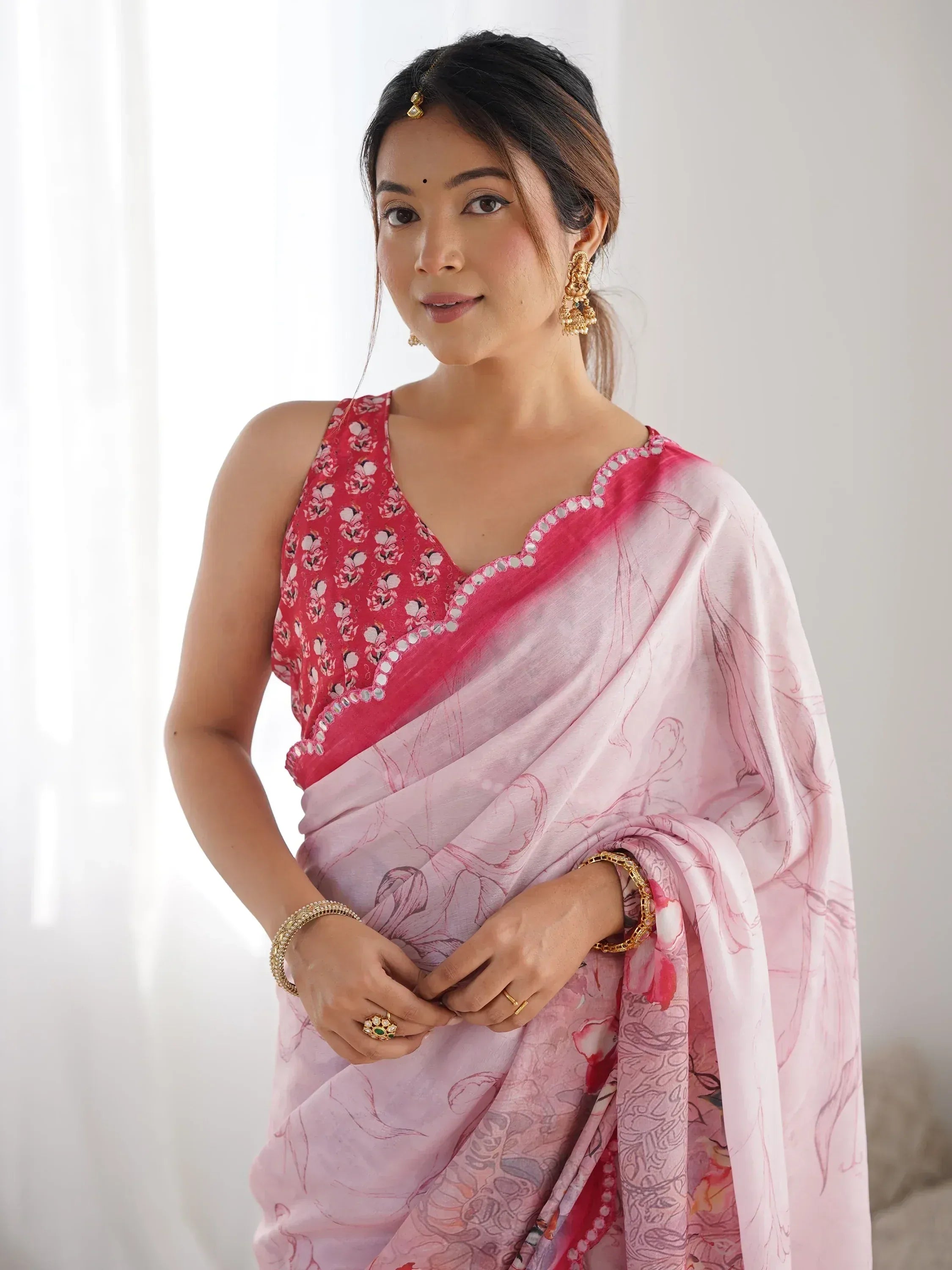 Woman in pink floral saree with embroidered blouse, traditional Indian ethnic wear