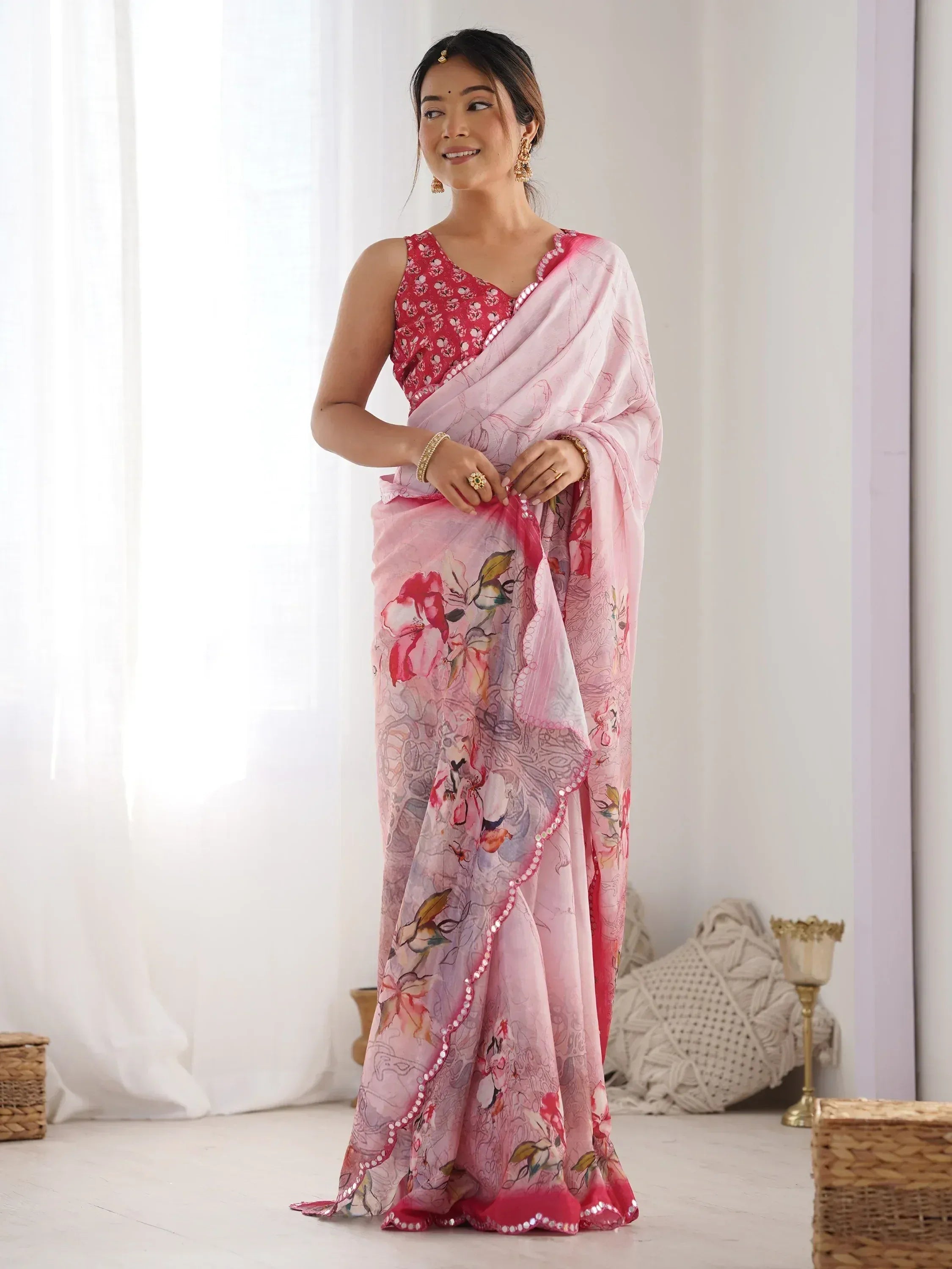 Woman in pink floral saree with sequin border, perfect for Indian ethnic wear occasions