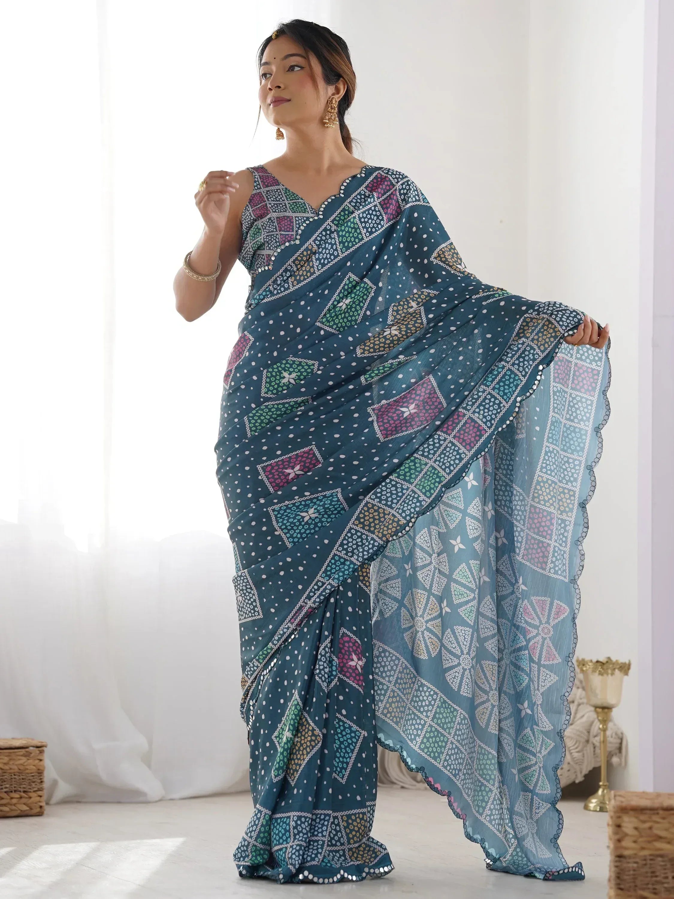 Woman in teal printed saree with geometric patterns, ethnic Indian wear for festive occasions