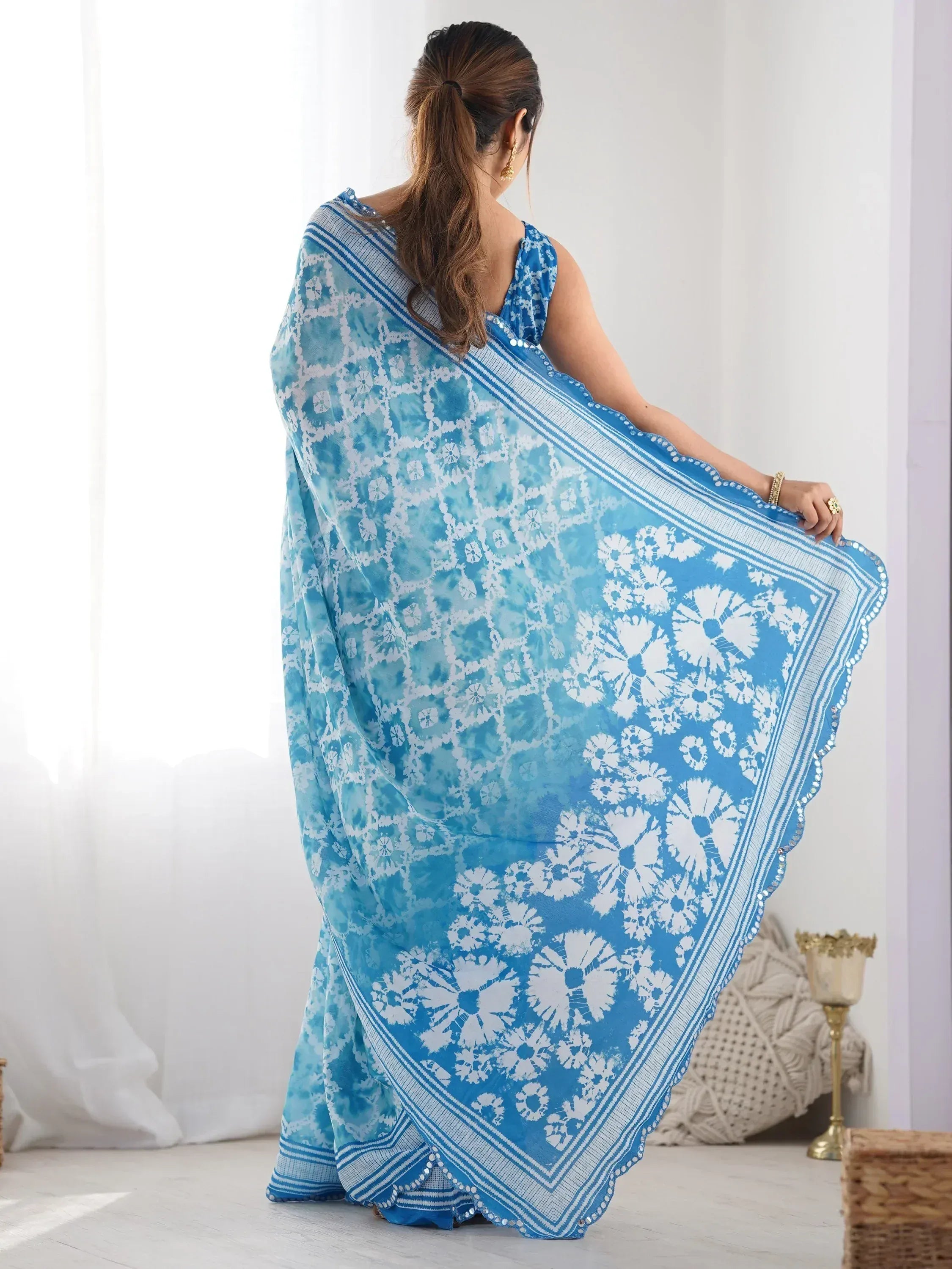 Blue and white floral printed saree with mirror work border, styled with matching blouse for ethnic wear