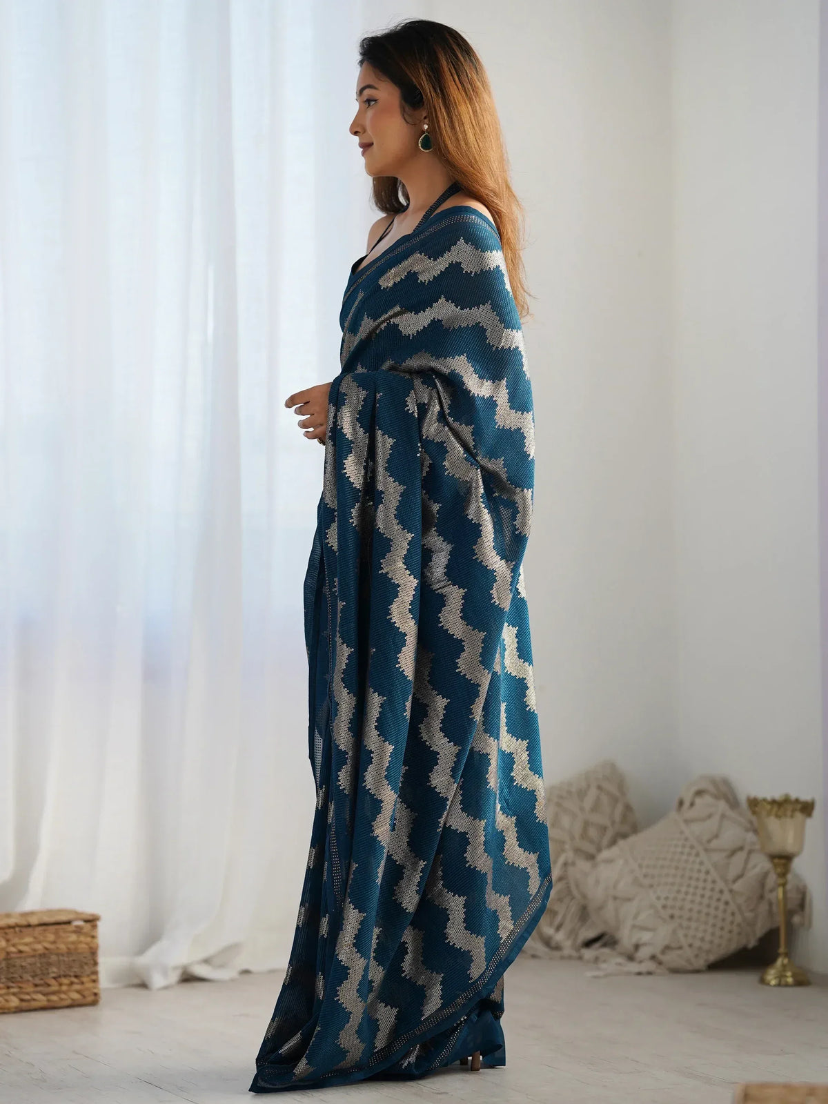 Woman in teal ethnic saree with geometric pattern, stylish Indian wear for festive occasions