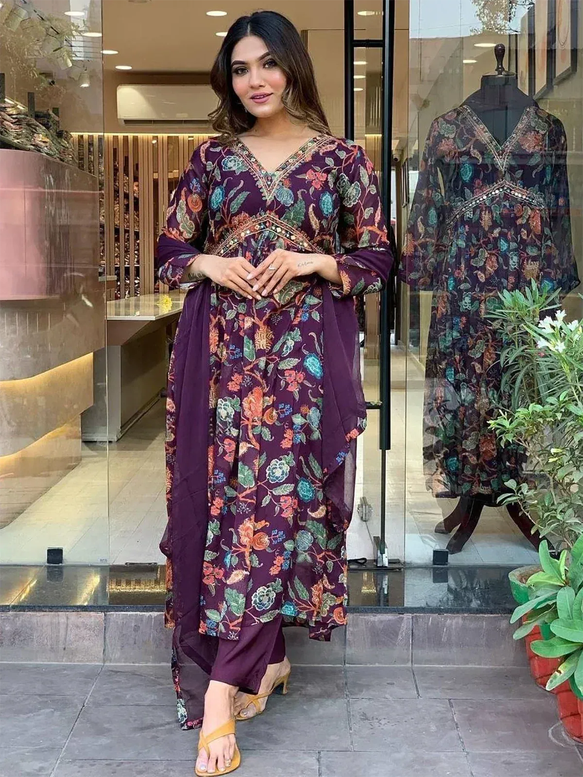 Woman in purple floral ethnic gown with matching pants, perfect for Indian occasions and parties