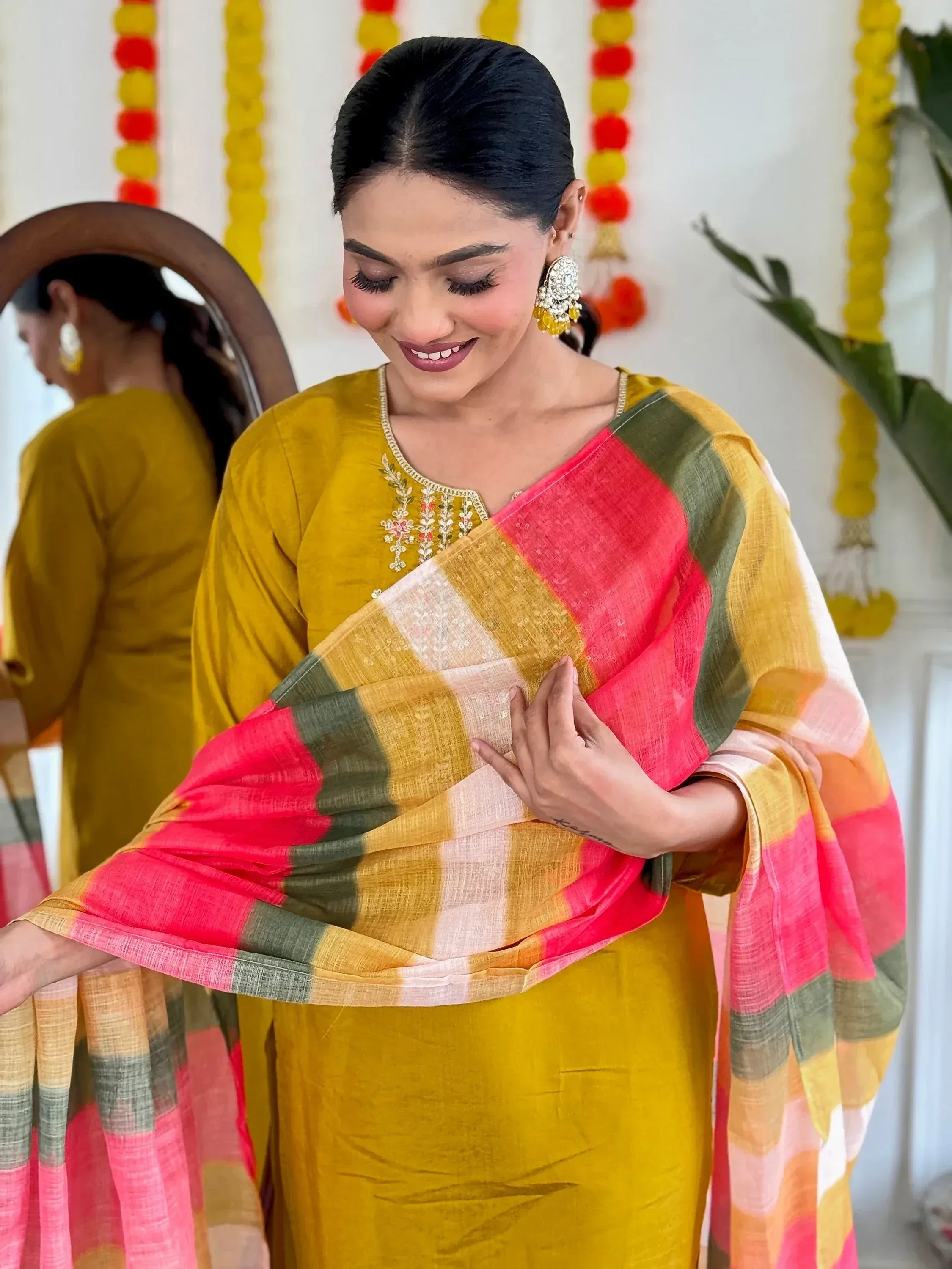Woman in yellow embroidered kurta with colorful checkered saree, festive Indian ethnic wear