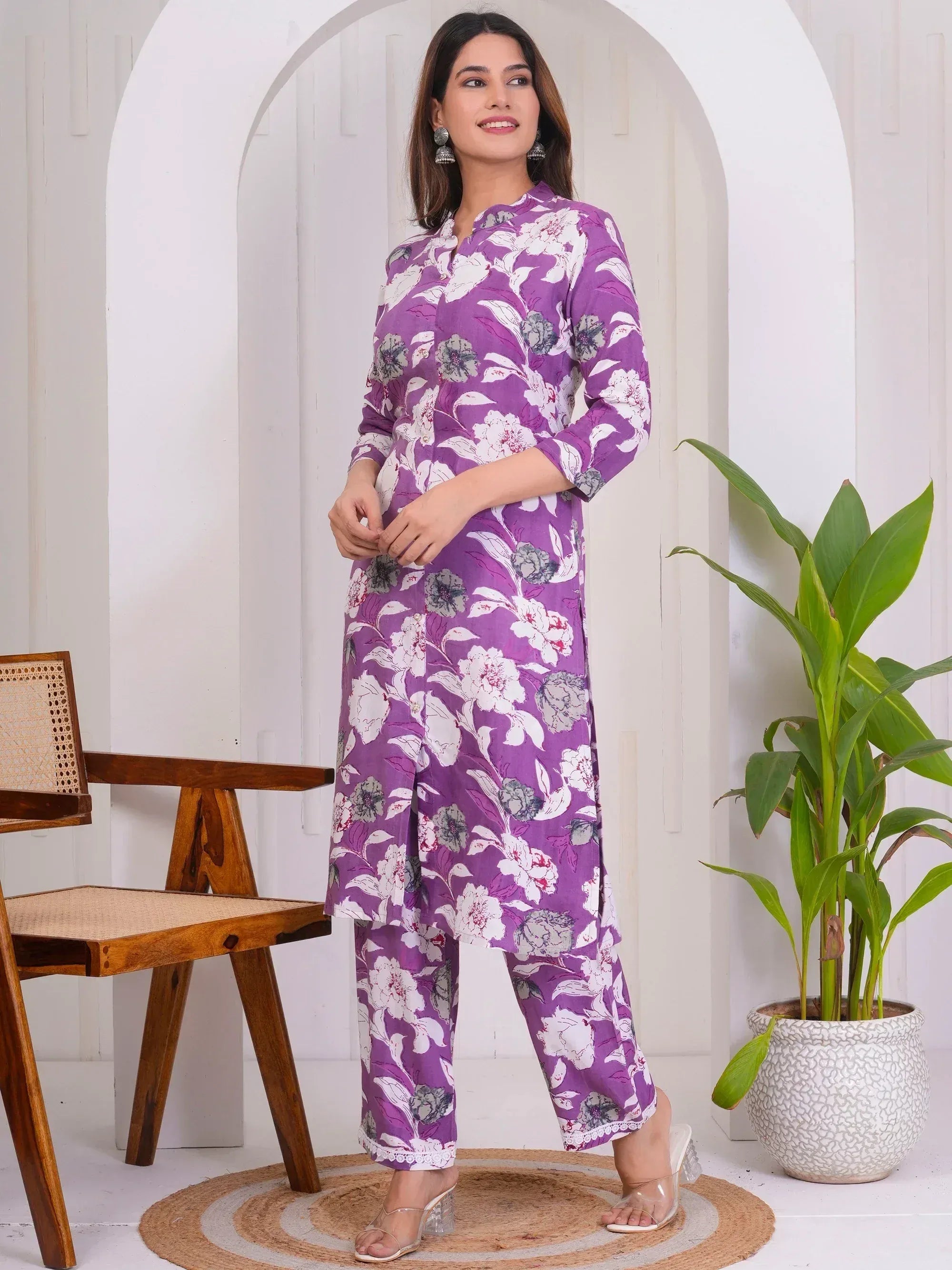 Purple floral print salwar kameez with white lace trim, styled for casual ethnic wear