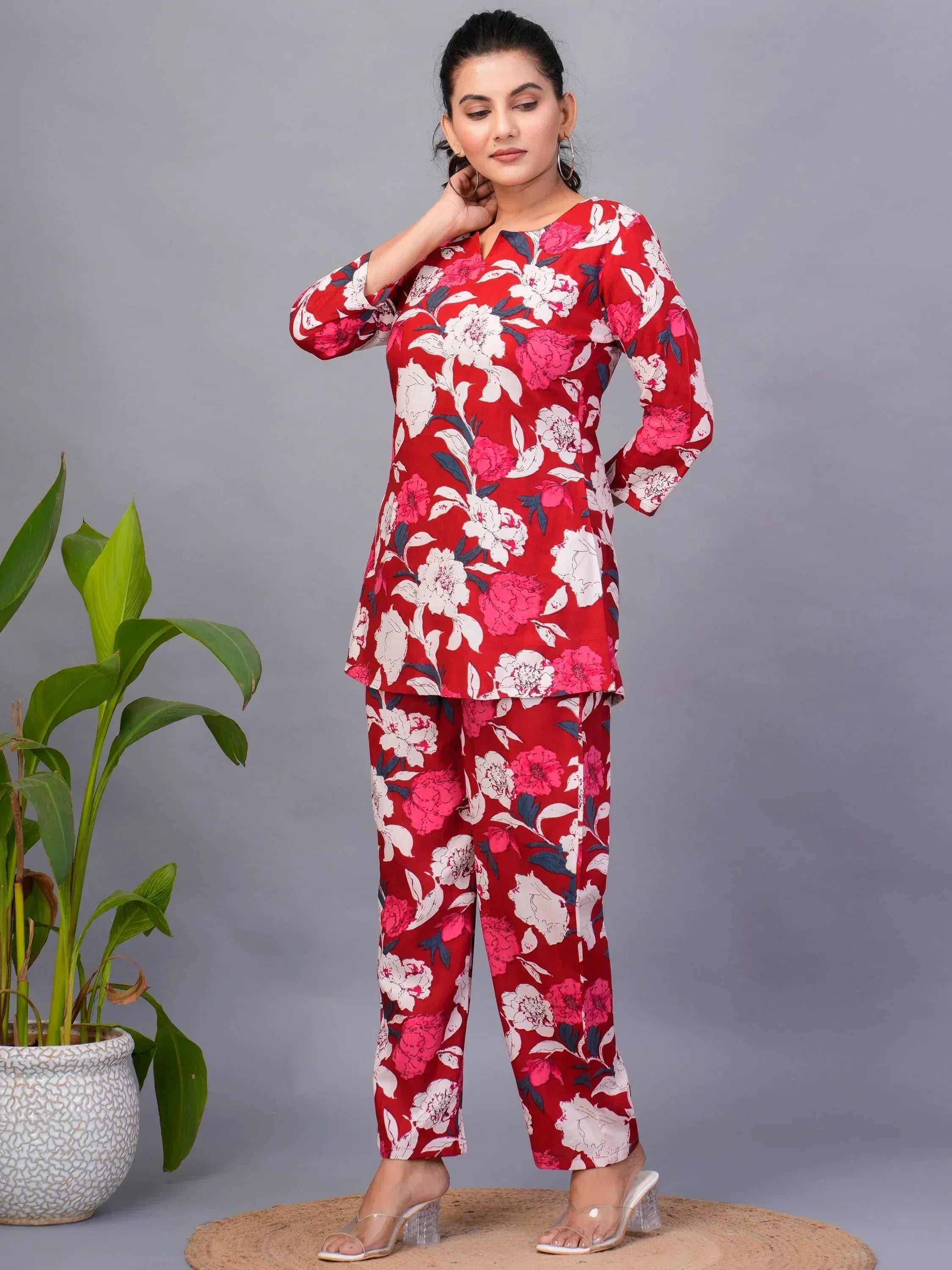 Red floral printed ethnic kurta pants set with white and pink blooms, styled for casual wear
