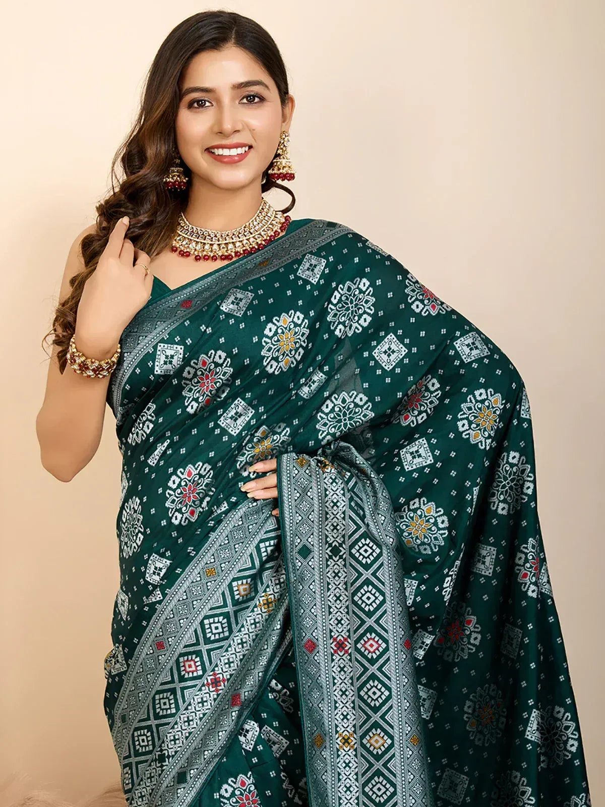 Elegant green printed saree with intricate floral and geometric patterns, paired with traditional jewelry.