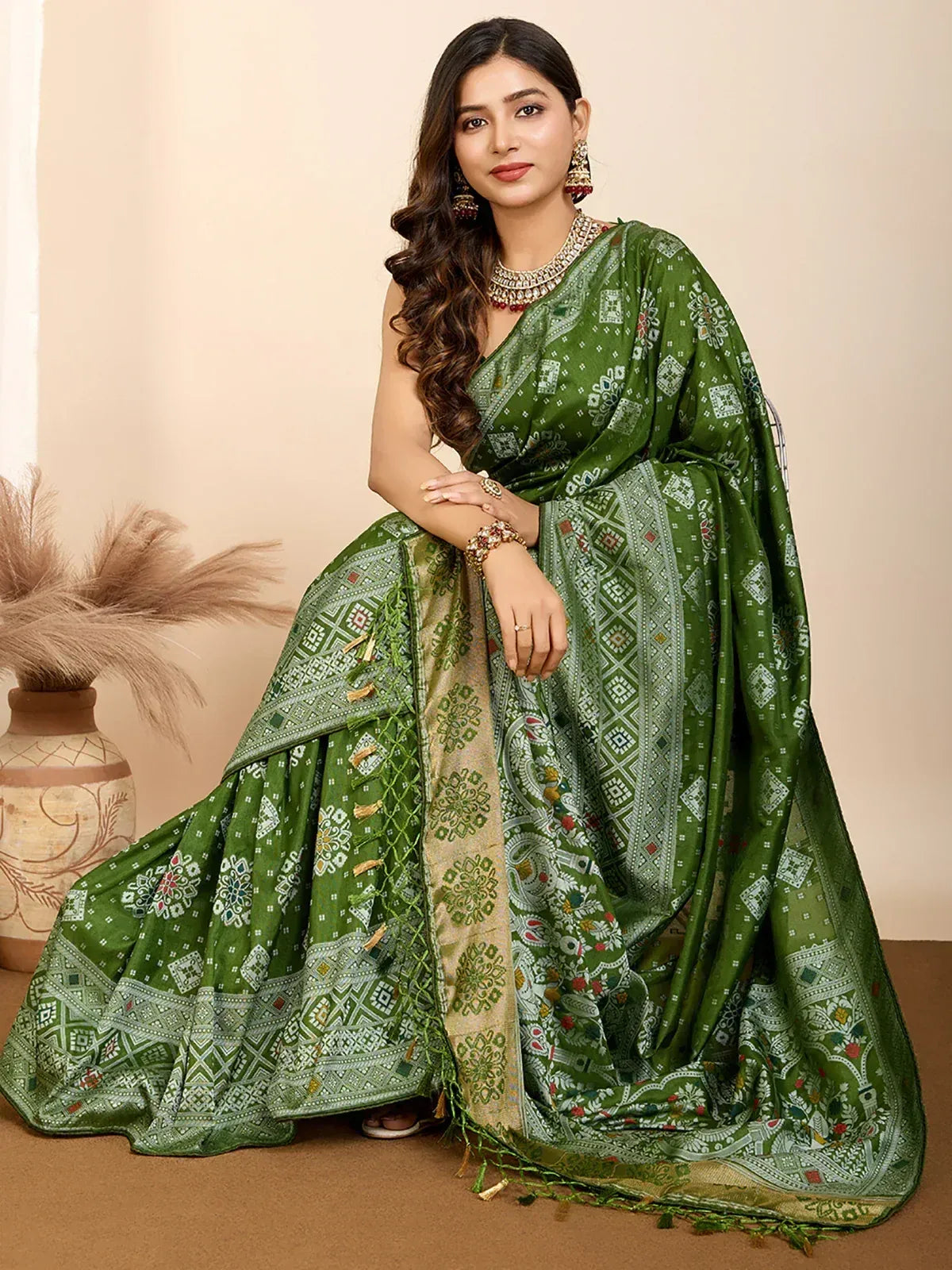 Green printed saree with intricate geometric and floral patterns, styled with traditional jewelry for ethnic wear.