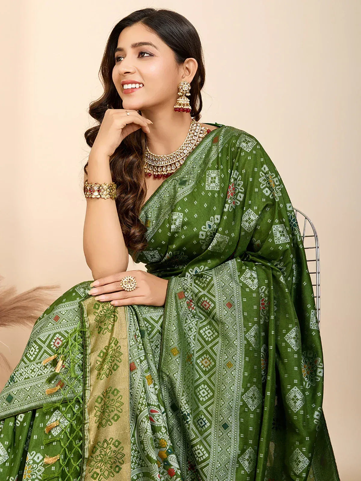 Green printed saree with ethnic jewelry, perfect for Indian occasions and festive wear.