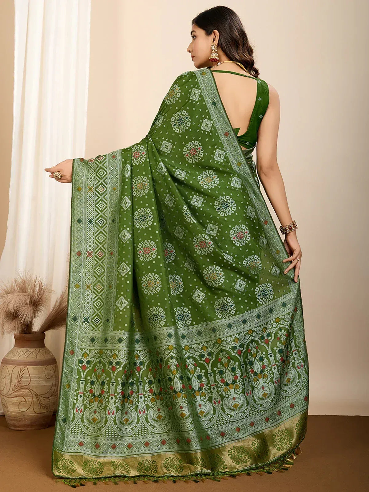 Green printed saree with intricate floral and geometric patterns, perfect for ethnic wear occasions