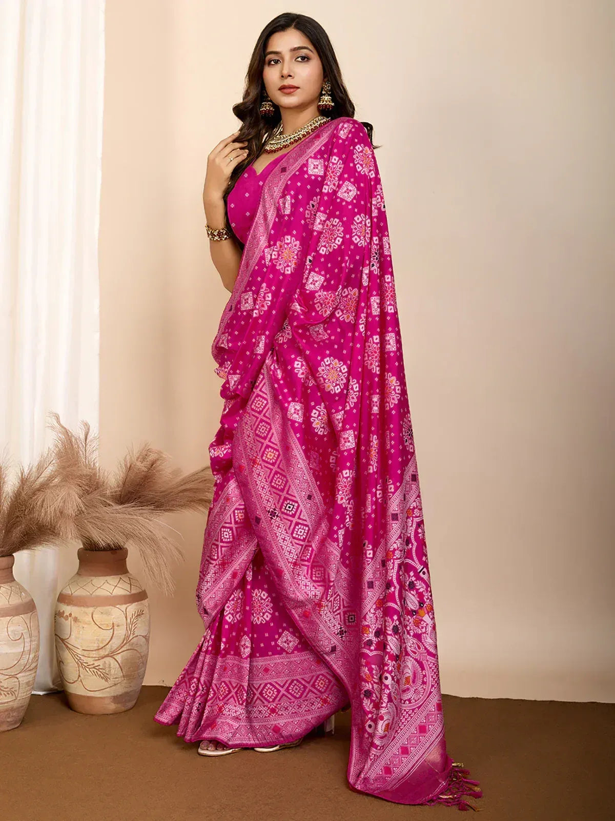 Vibrant pink printed saree with ethnic motifs, perfect for Indian festive occasions and traditional wear.