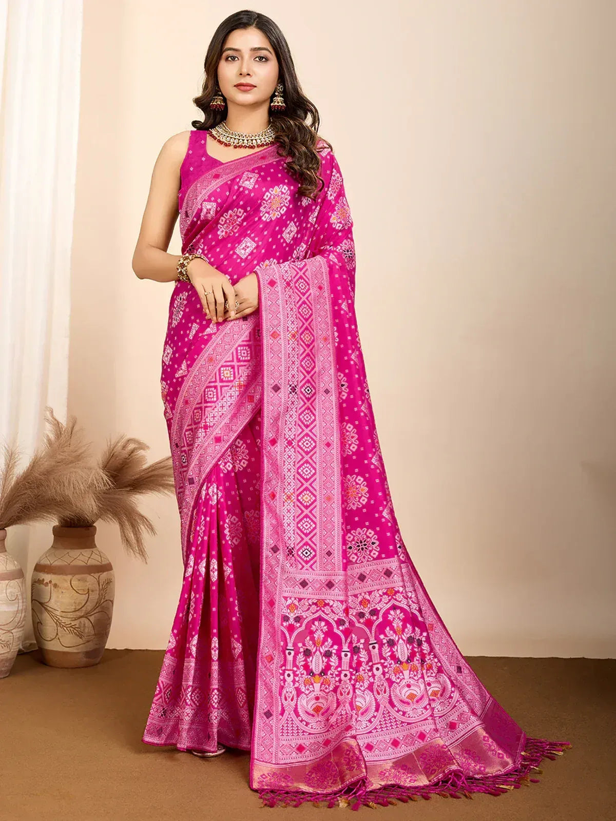 Vibrant pink ethnic saree with intricate white and gold block print patterns, perfect for festive occasions.