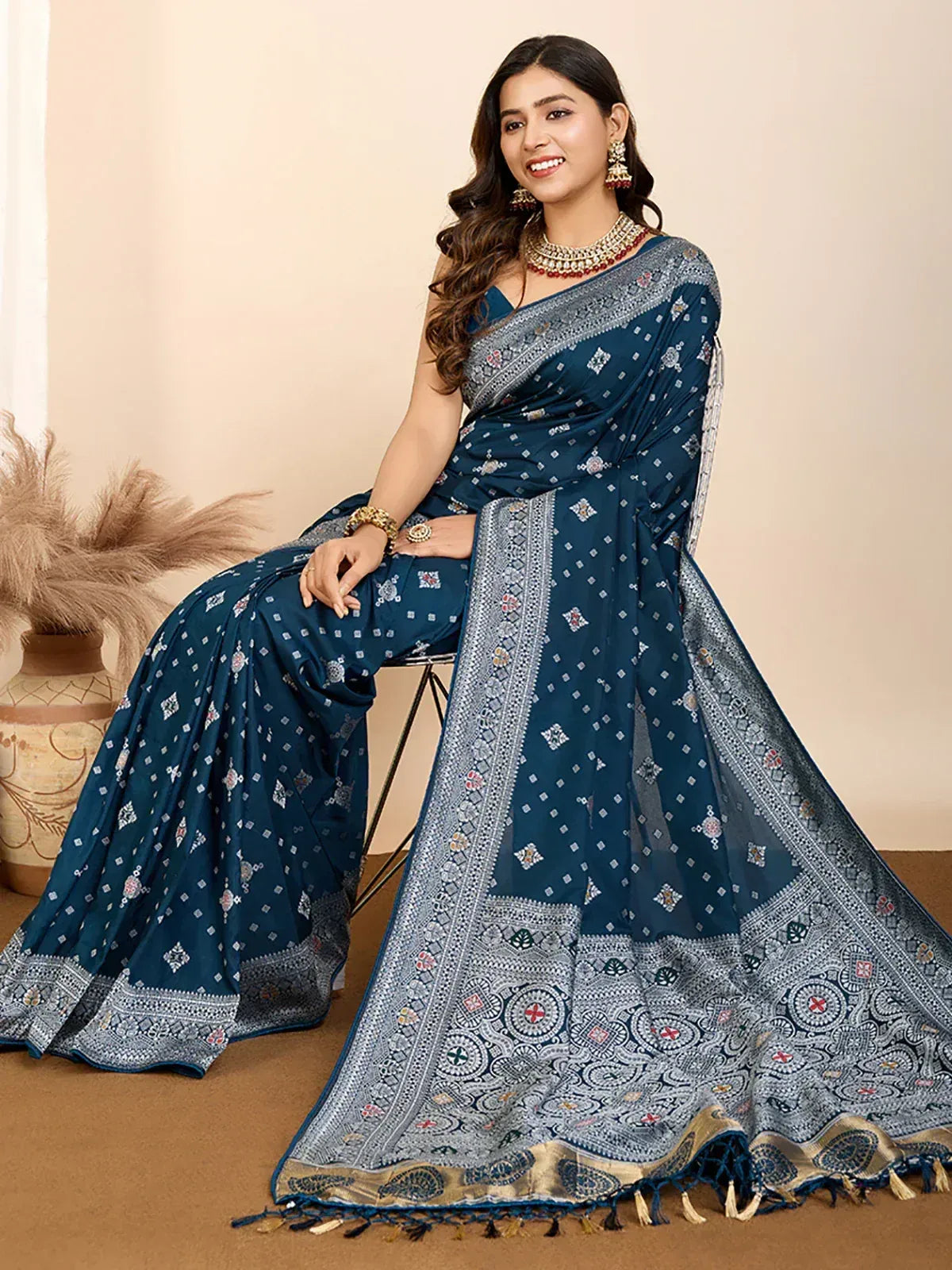 Blue printed saree with intricate border and tassels, styled with traditional jewelry for ethnic wear