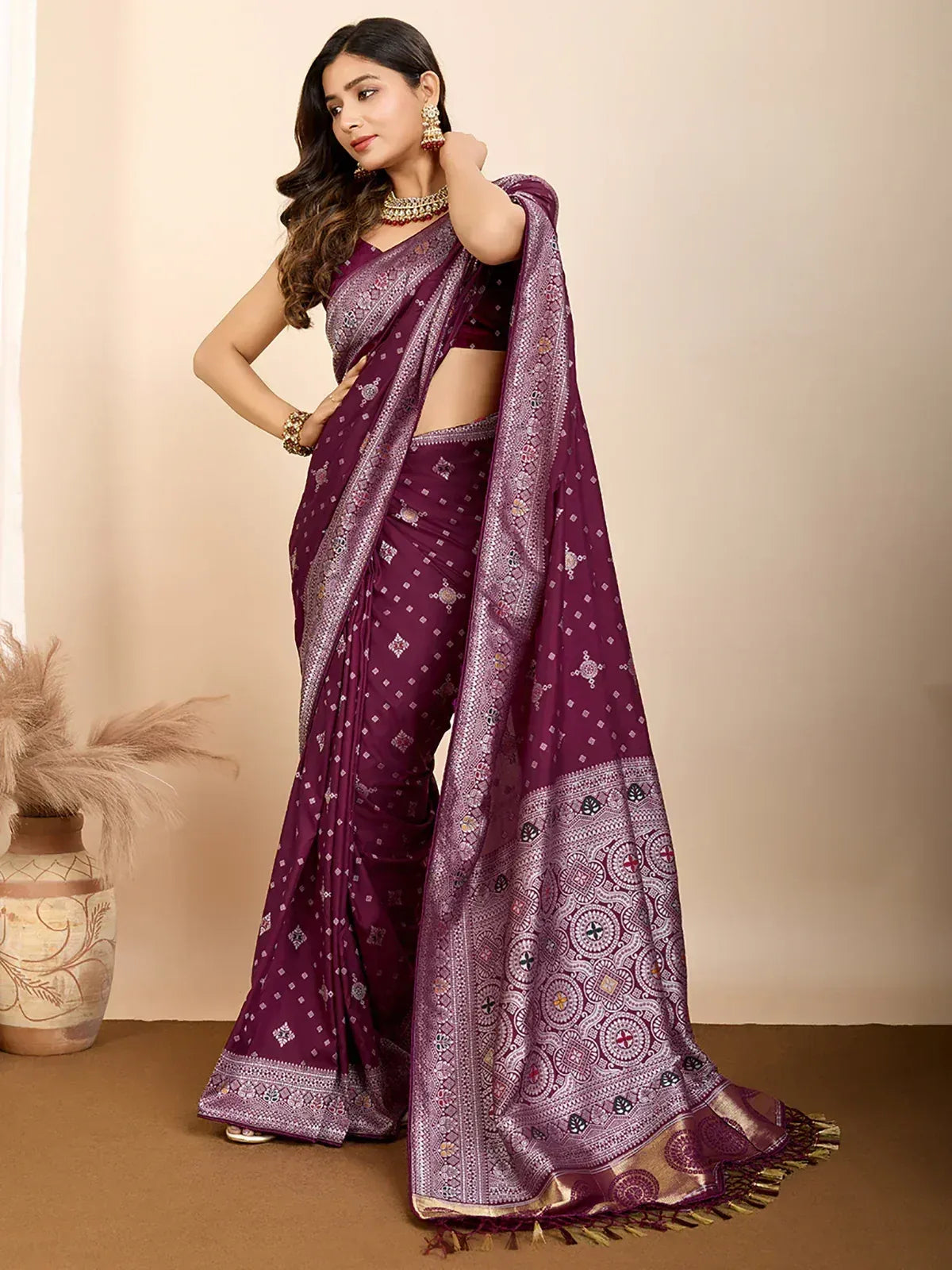 Purple ethnic saree with intricate print and gold border, styled with traditional jewelry for festive occasions