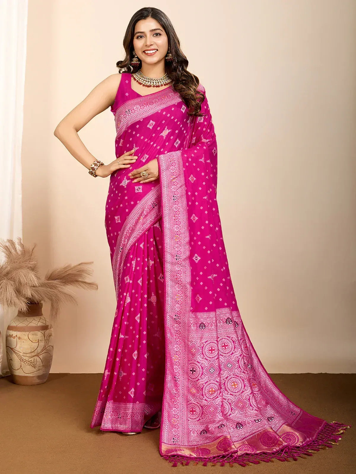 Vibrant pink ethnic saree with intricate patterns and border design, perfect for festive occasions.