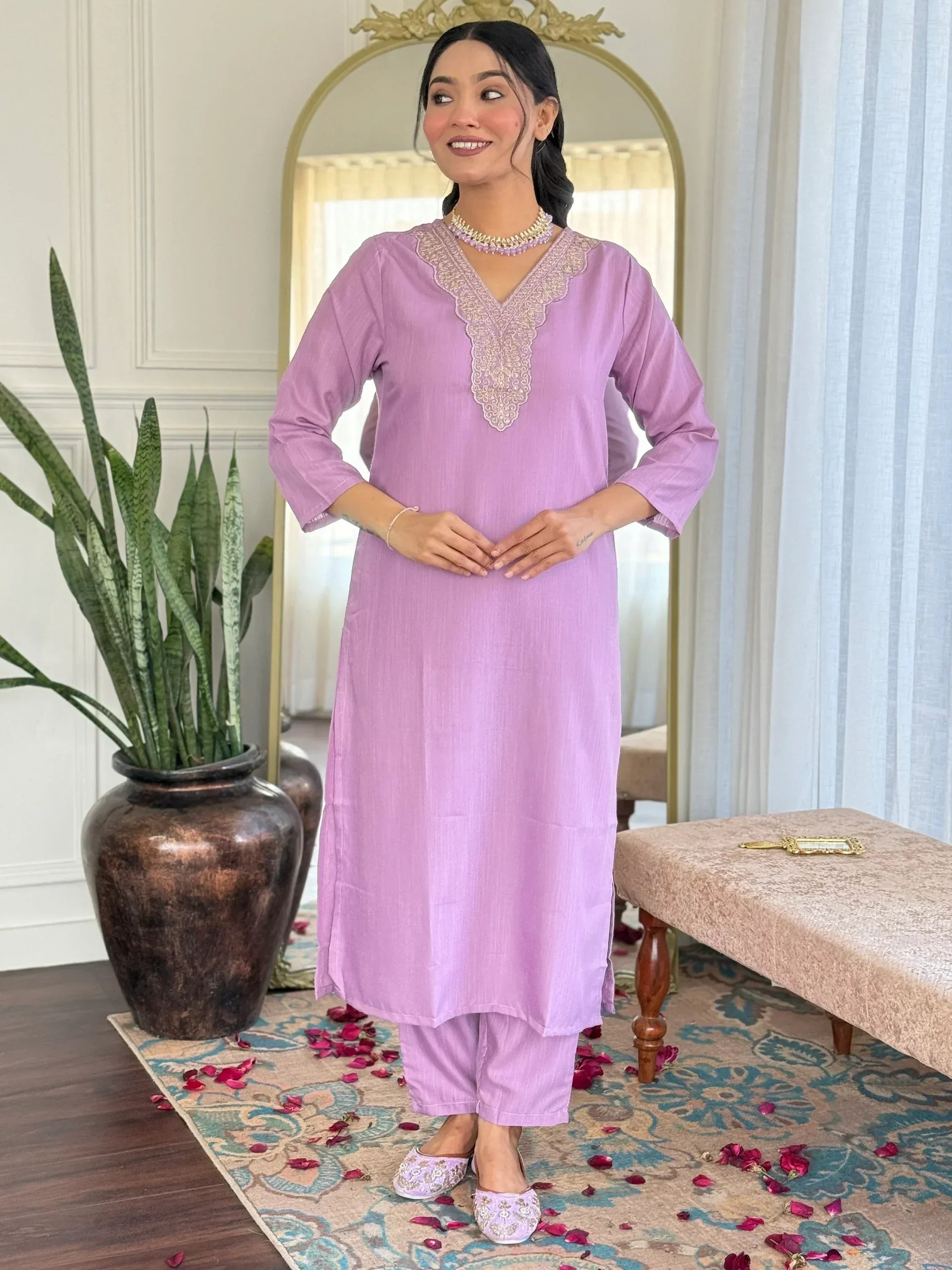 Lavender ethnic kurta with embroidered neckline paired with matching pants and embellished slippers