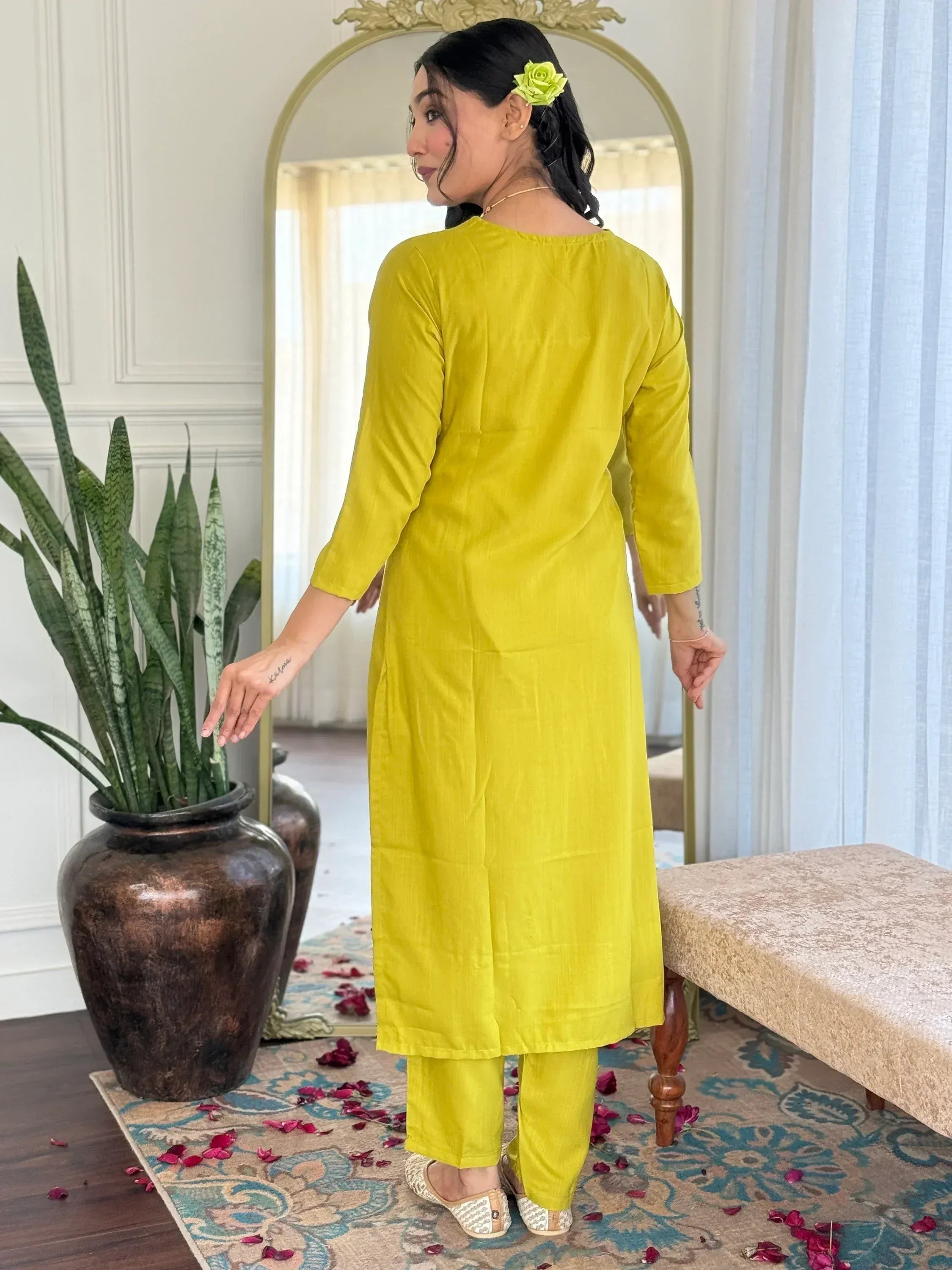 Yellow ethnic kurta set with matching pants, styled with floral hair accessory and traditional flats