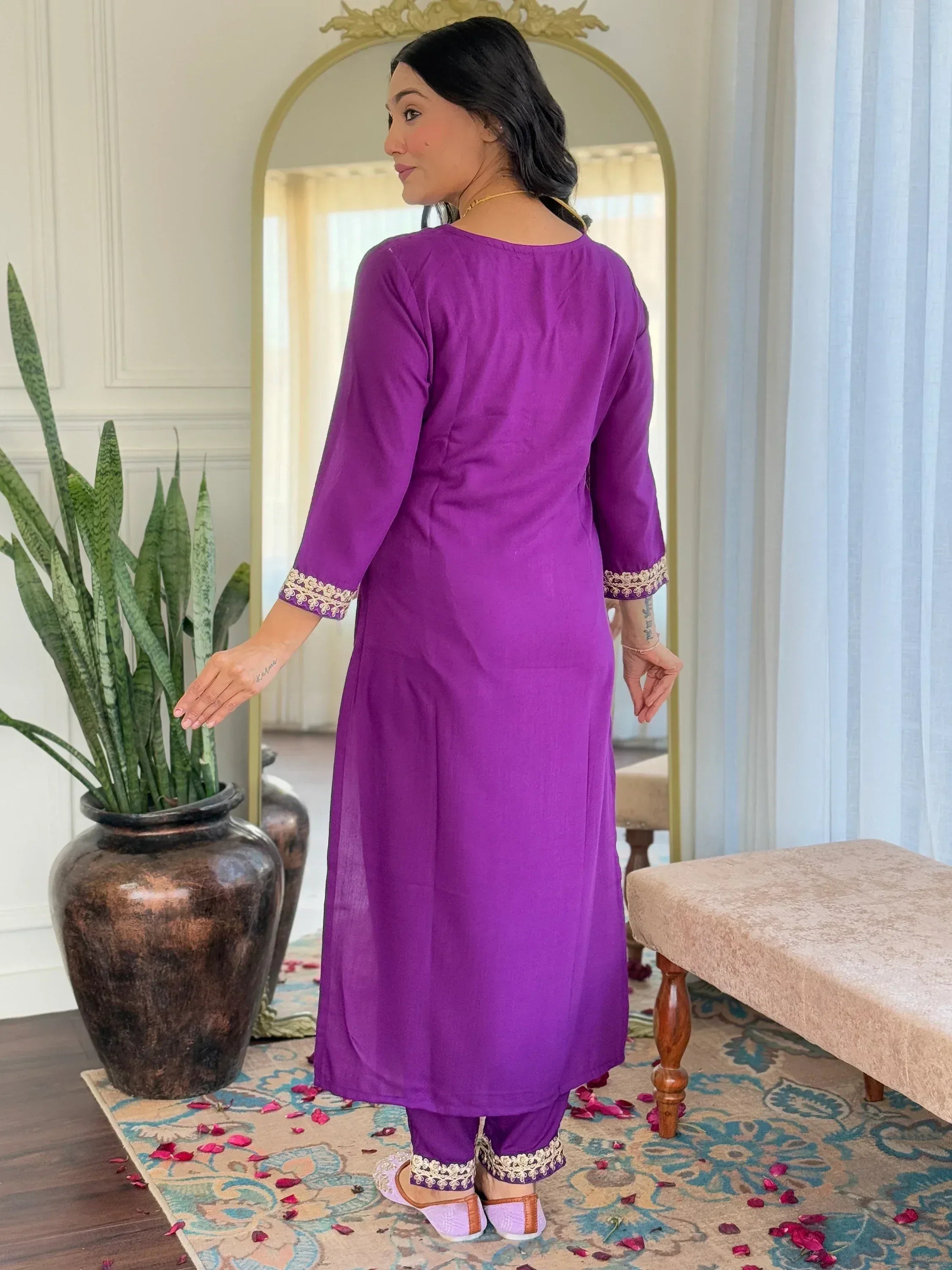 Purple ethnic kurti with gold embroidery, paired with matching pants and traditional footwear