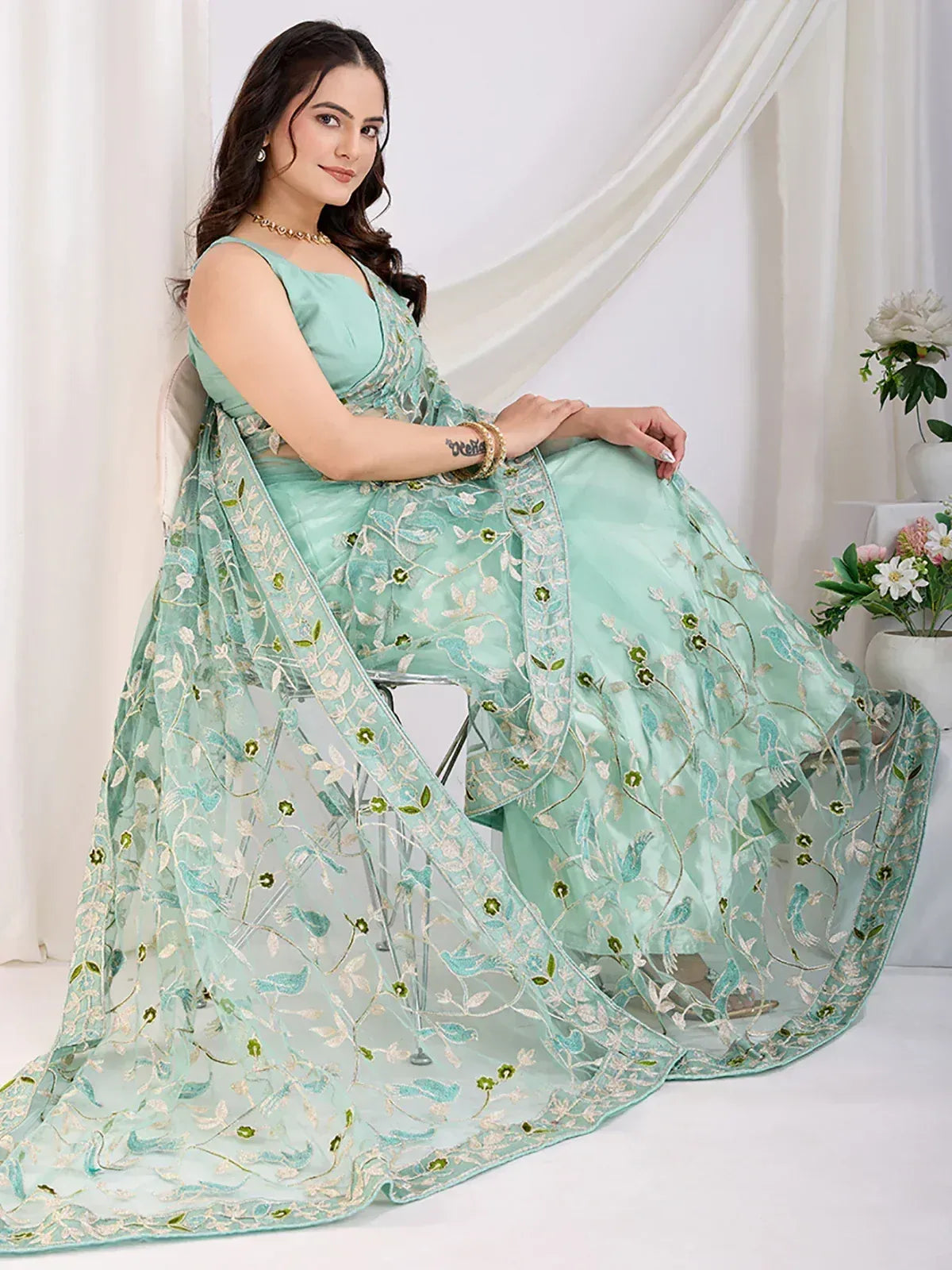 Mint green designer lehenga choli with floral embroidery, perfect for Indian ethnic wear occasions.