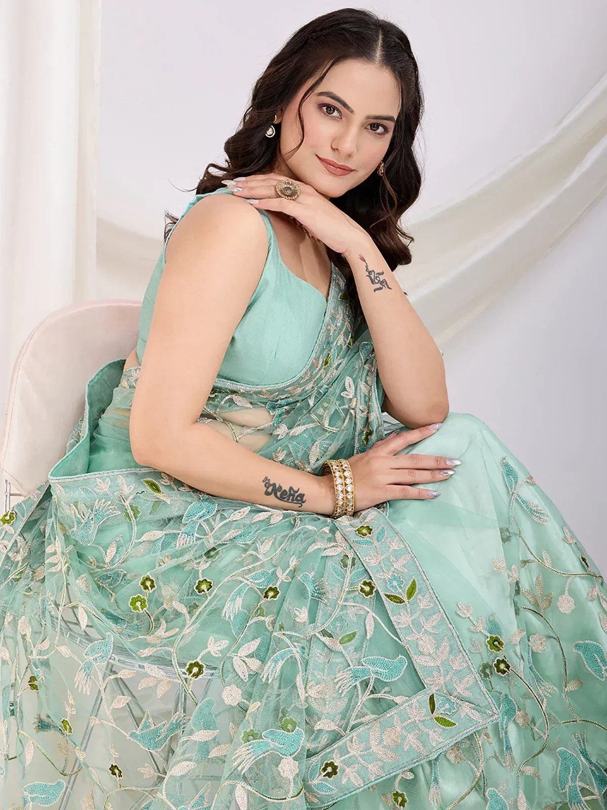 Mint green embroidered lehenga choli with floral net dupatta, perfect for Indian ethnic occasions