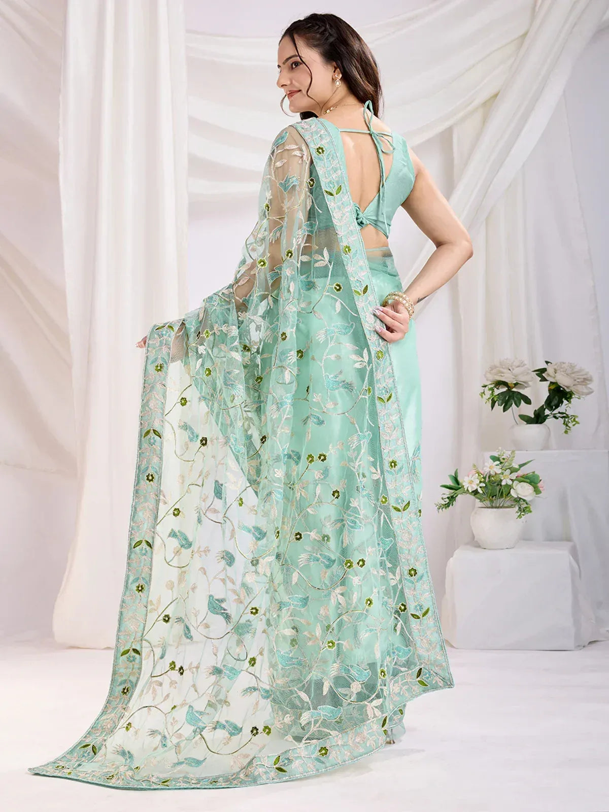 Mint green embroidered saree with floral and bird motifs, sheer dupatta, backless blouse for ethnic wear