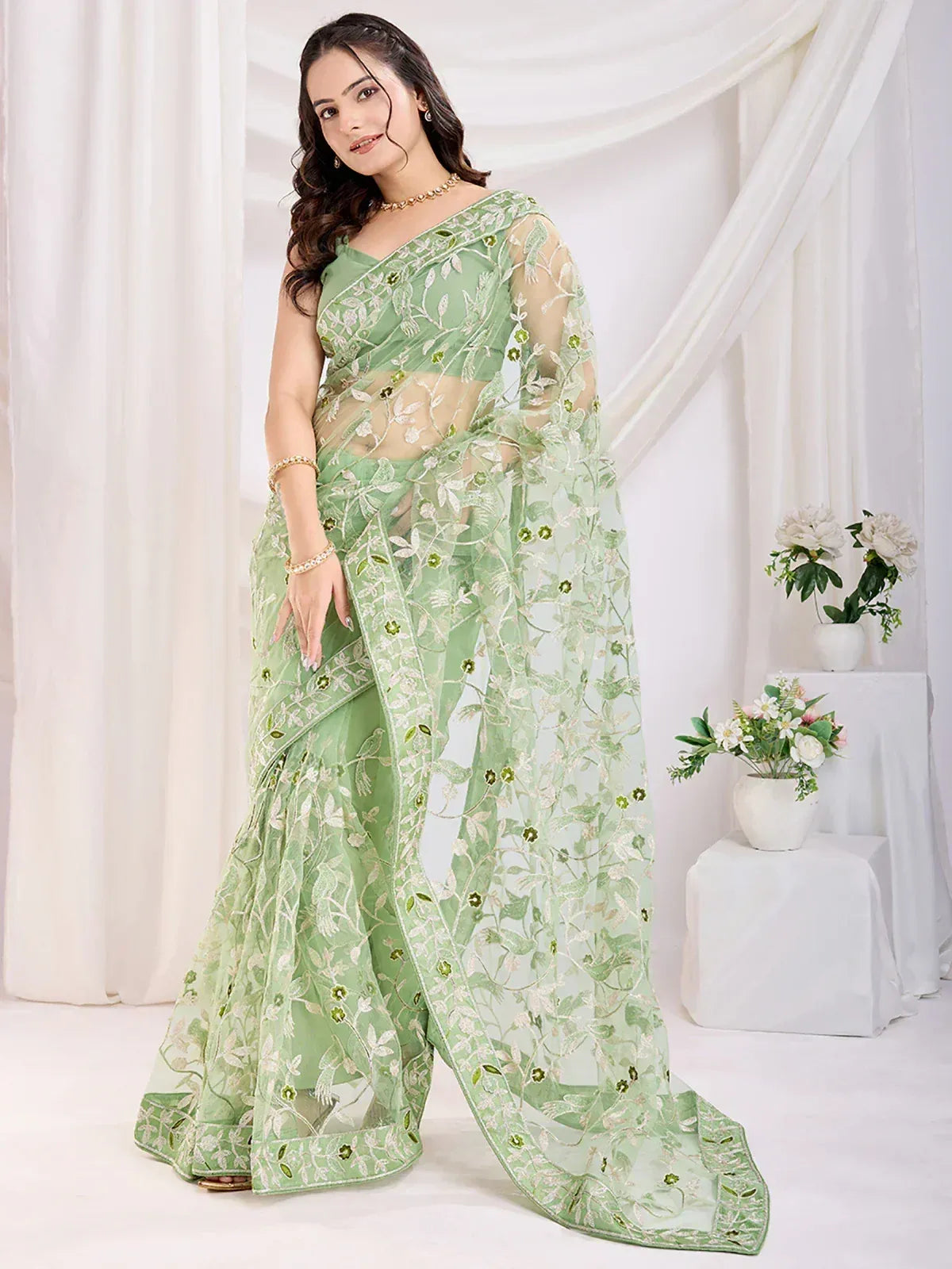 Light green embroidered saree with floral design, perfect for Indian ethnic wear occasions