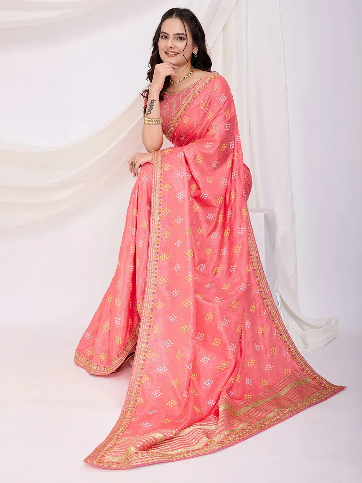 Pink ethnic saree with gold and white geometric print, perfect for Indian occasions