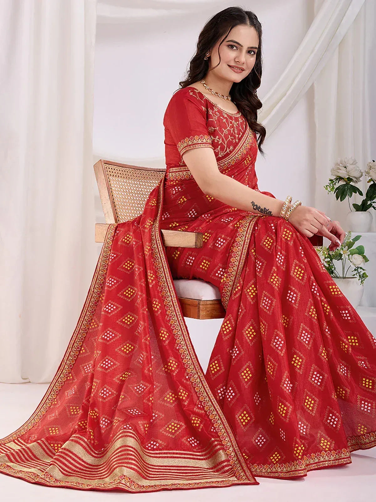Red ethnic saree with gold geometric print and embroidered border, perfect for Indian occasions