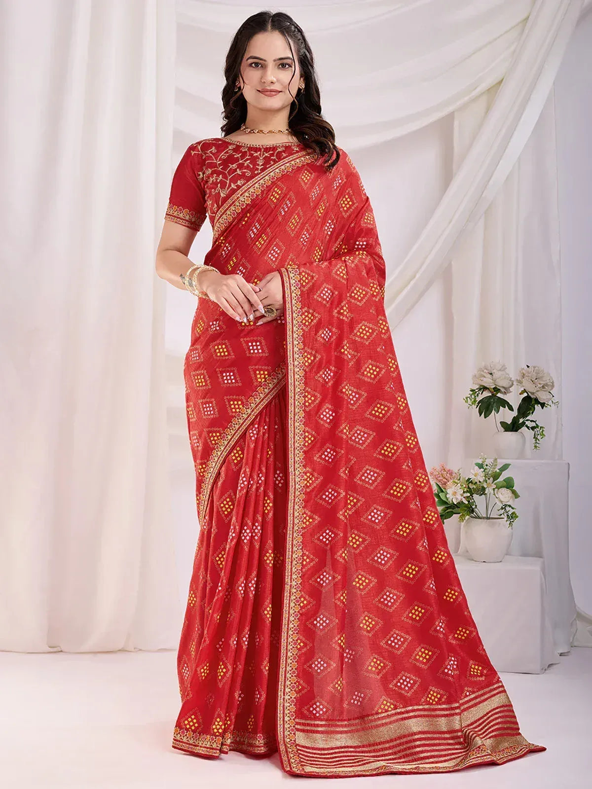 Red ethnic saree with gold geometric print and embroidered border, styled with matching blouse for Indian occasions