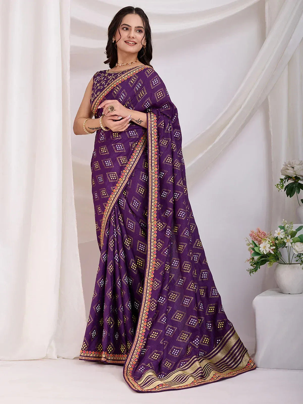 Purple ethnic saree with geometric print and gold border, styled for Indian occasions