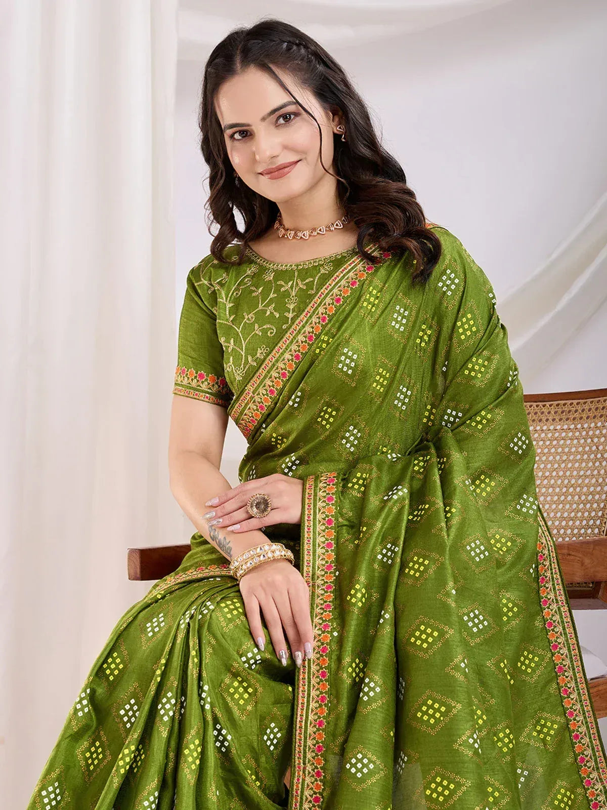 Green embroidered saree with mirror work and floral border, perfect for Indian ethnic occasions