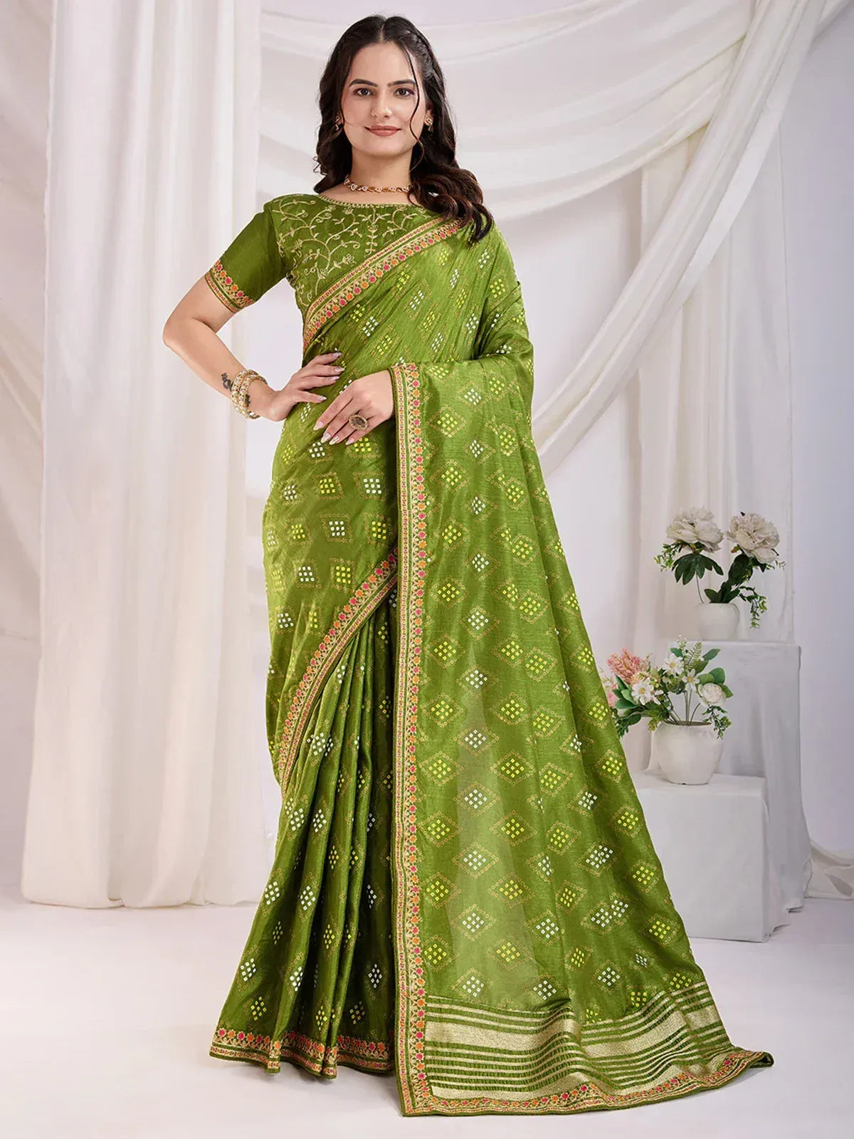 Green embroidered saree with geometric print, perfect for Indian ethnic wear occasions