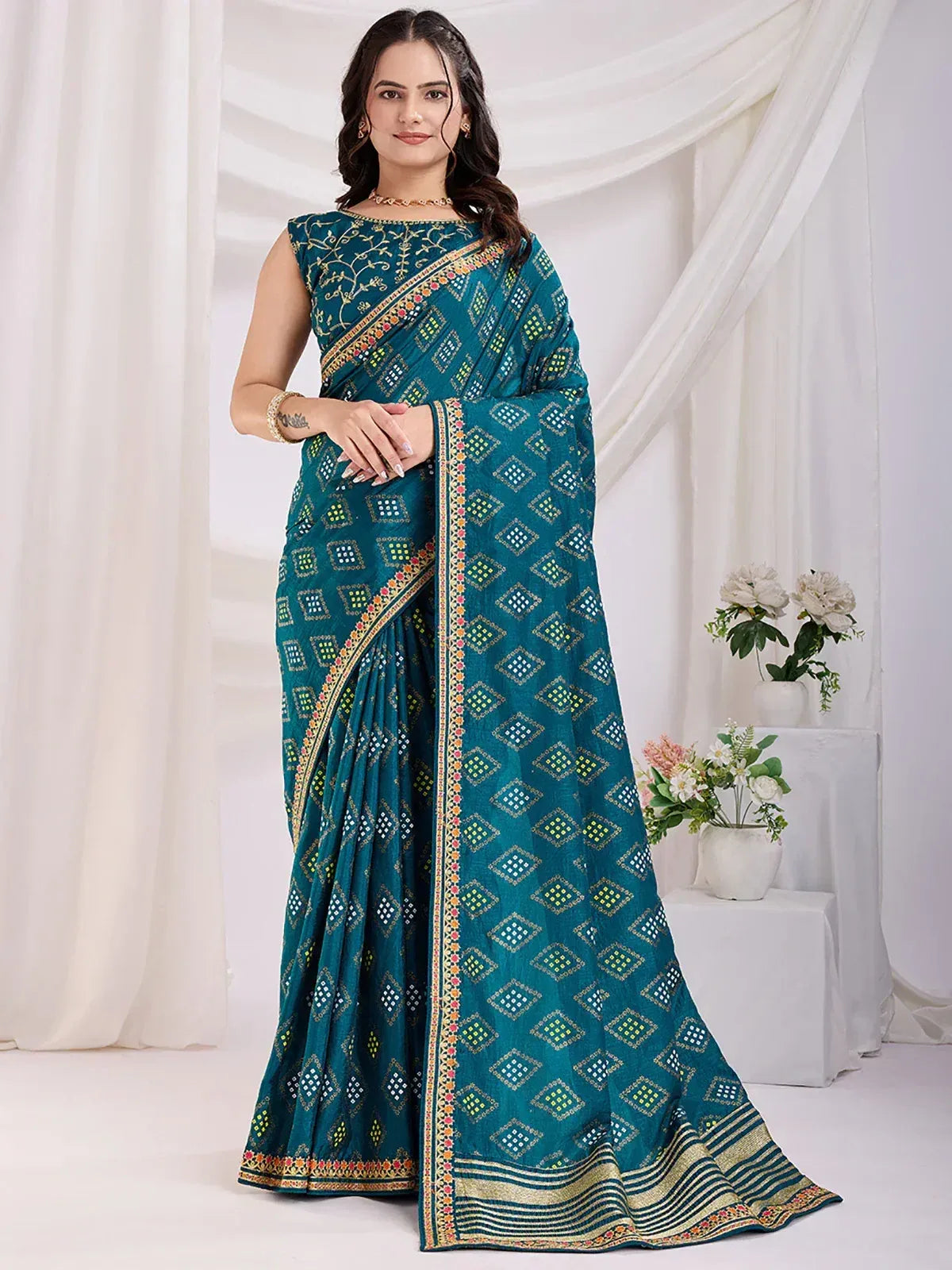 Teal ethnic saree with geometric print and embroidered border, perfect for Indian occasions