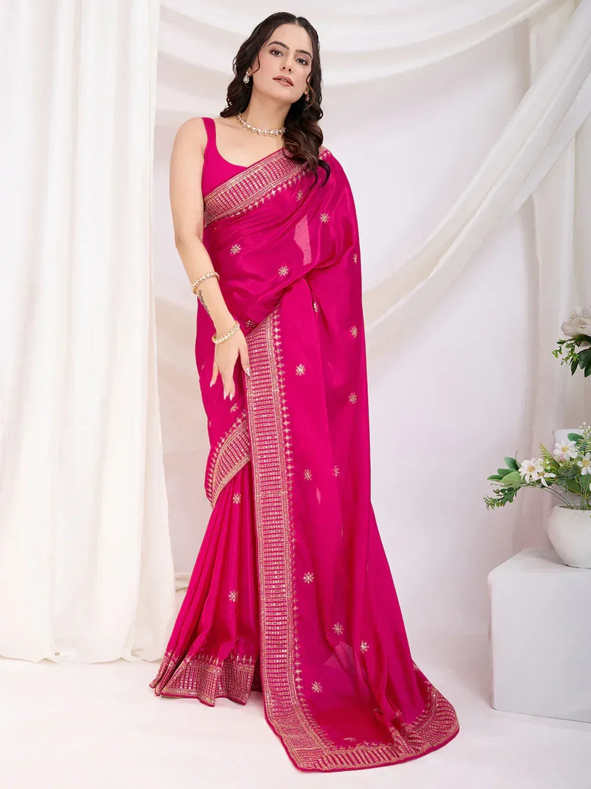 Fuchsia pink embroidered saree with gold border, perfect for Indian ethnic occasions